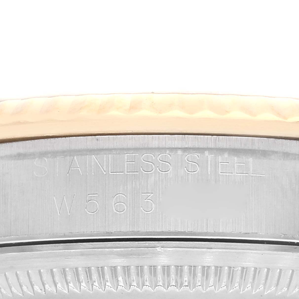 This image shows a close-up of the case back and edge of the bezel of a Rolex Datejust 16233 Men's Steel and Gold (two tone) White Dial 16233 Men's Steel and Gold (two tone) White Dial watch, highlighting the stainless steel material.