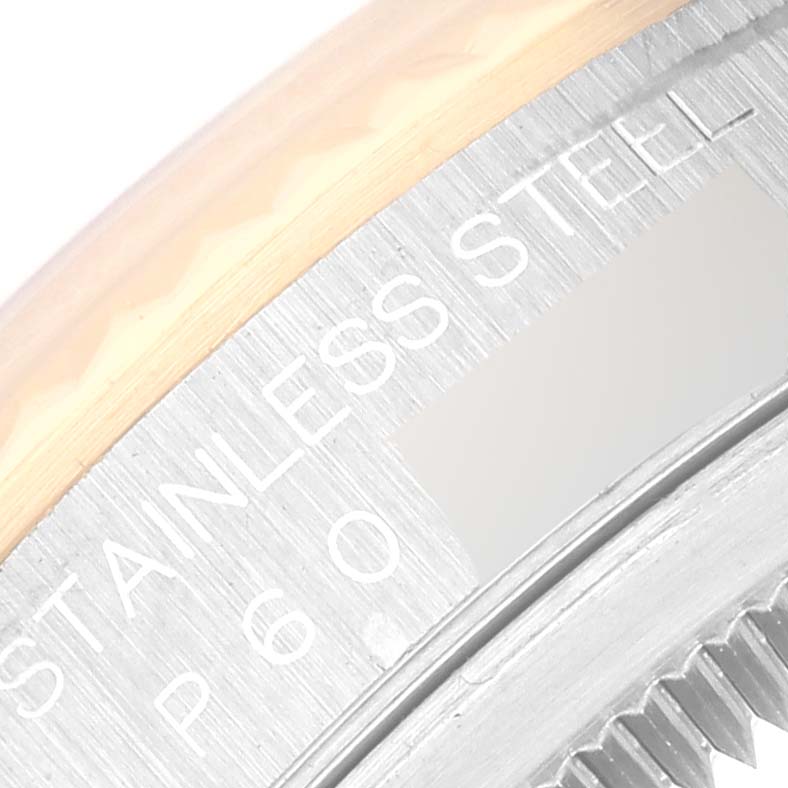 The image shows a close-up of the side of a stainless steel Rolex Datejust 16233 Men's Steel and Gold (two tone) White Dial 16233 Men's Steel and Gold (two tone) White Dial watch, highlighting part of the bezel.