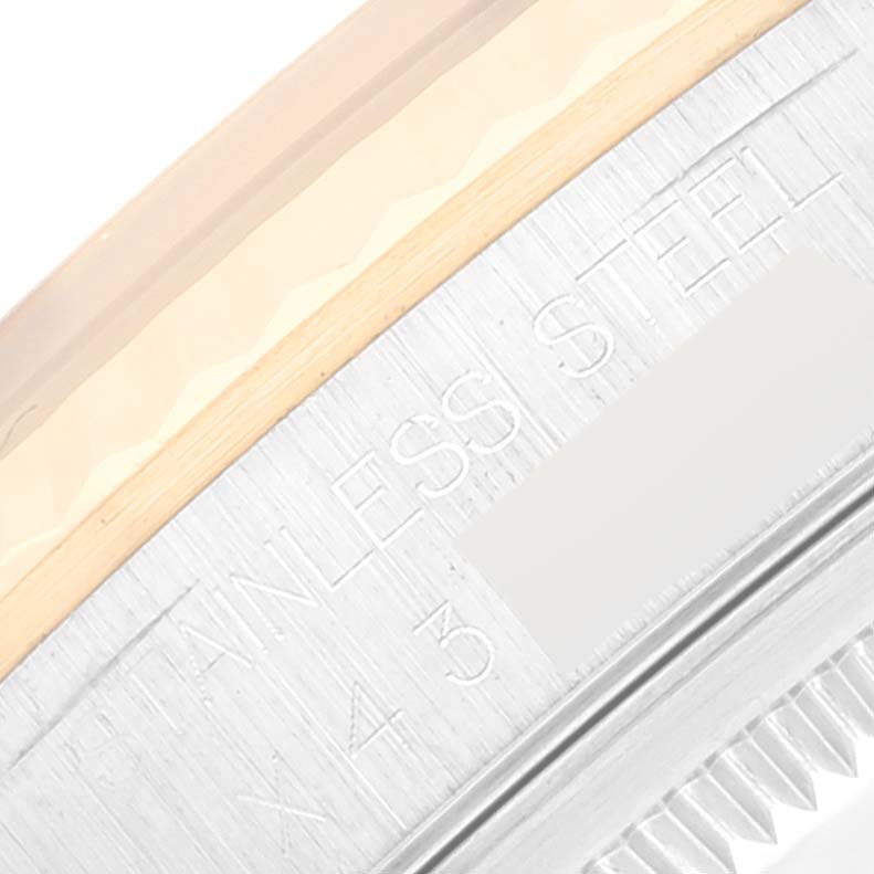 The image shows a close-up of the side of a Rolex Datejust 16233 Men's Steel and Gold (two tone) Champagne Dial 16233 Men's Steel and Gold (two tone) Champagne Dial watch, highlighting stainless steel text and part of the bezel.