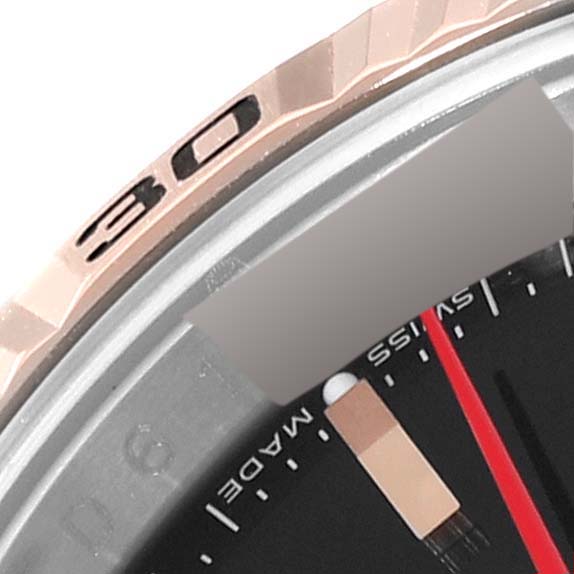 The image shows a close-up angle of the bezel and part of the dial of a Rolex Turn-o-Graph 116261 Men's Steel and Gold (two tone) Black Dial 116261 Men's Steel and Gold (two tone) Black Dial watch.