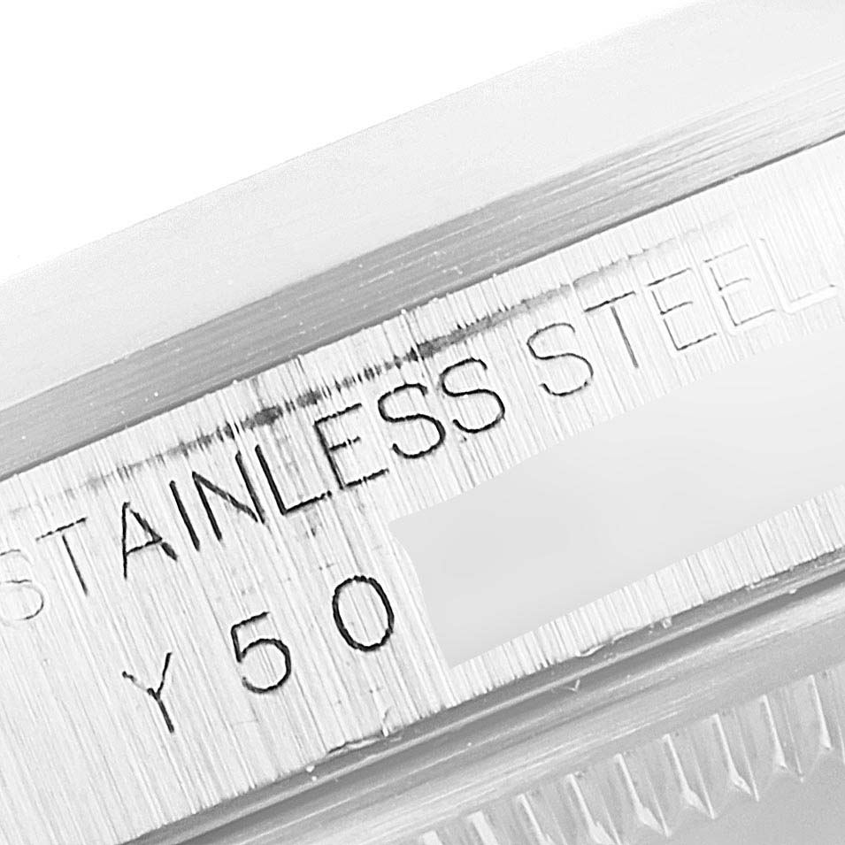 This image shows a close-up of the stainless steel bezel with engraved text on a Rolex Datejust 16200 Men
s Stainless Steel White Dial 16200 Men
s Stainless Steel White Dial watch.