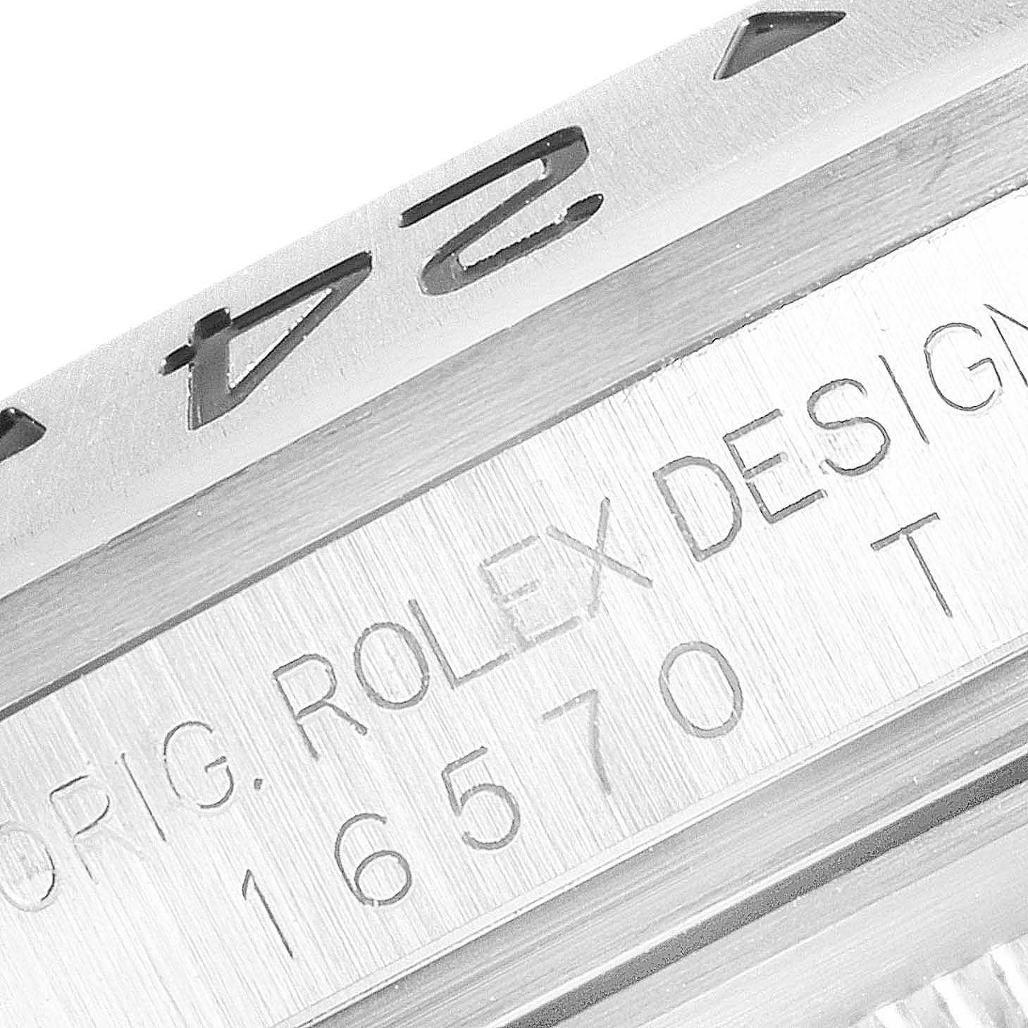 The image shows a close-up of the bezel and case engraving of a Rolex Explorer 16570 Men
s Stainless Steel Black Dial 16570 Men
s Stainless Steel Black Dial model 16570.