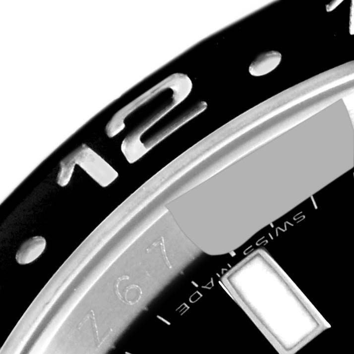 This close-up image shows the bezel and partial dial of a Rolex GMT-Master 116710 Men
s Stainless Steel Black Dial 116710 Men
s Stainless Steel Black Dial watch.