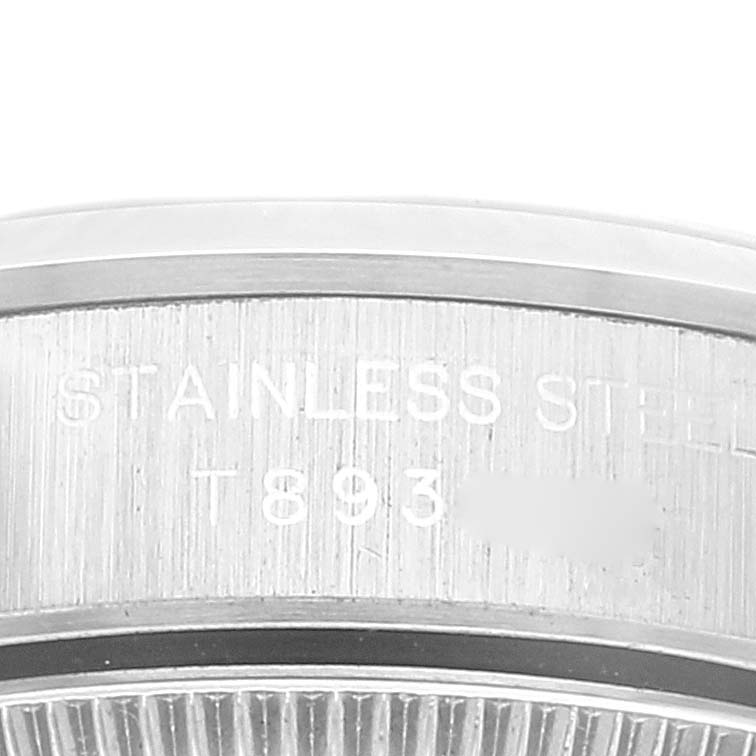 This image shows a close-up of the side of a Rolex Oyster Perpetual 67180 Women's Stainless Steel Black Dial 67180 Women's Stainless Steel Black Dial watch, highlighting "Stainless Steel" engraving.