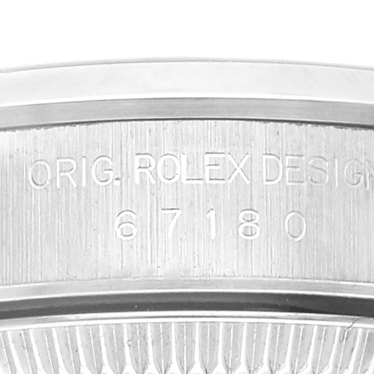 The image shows an up-close view of the engraved serial number and bezel edge of a Rolex Oyster Perpetual 67180 Women's Stainless Steel Black Dial 67180 Women's Stainless Steel Black Dial watch.