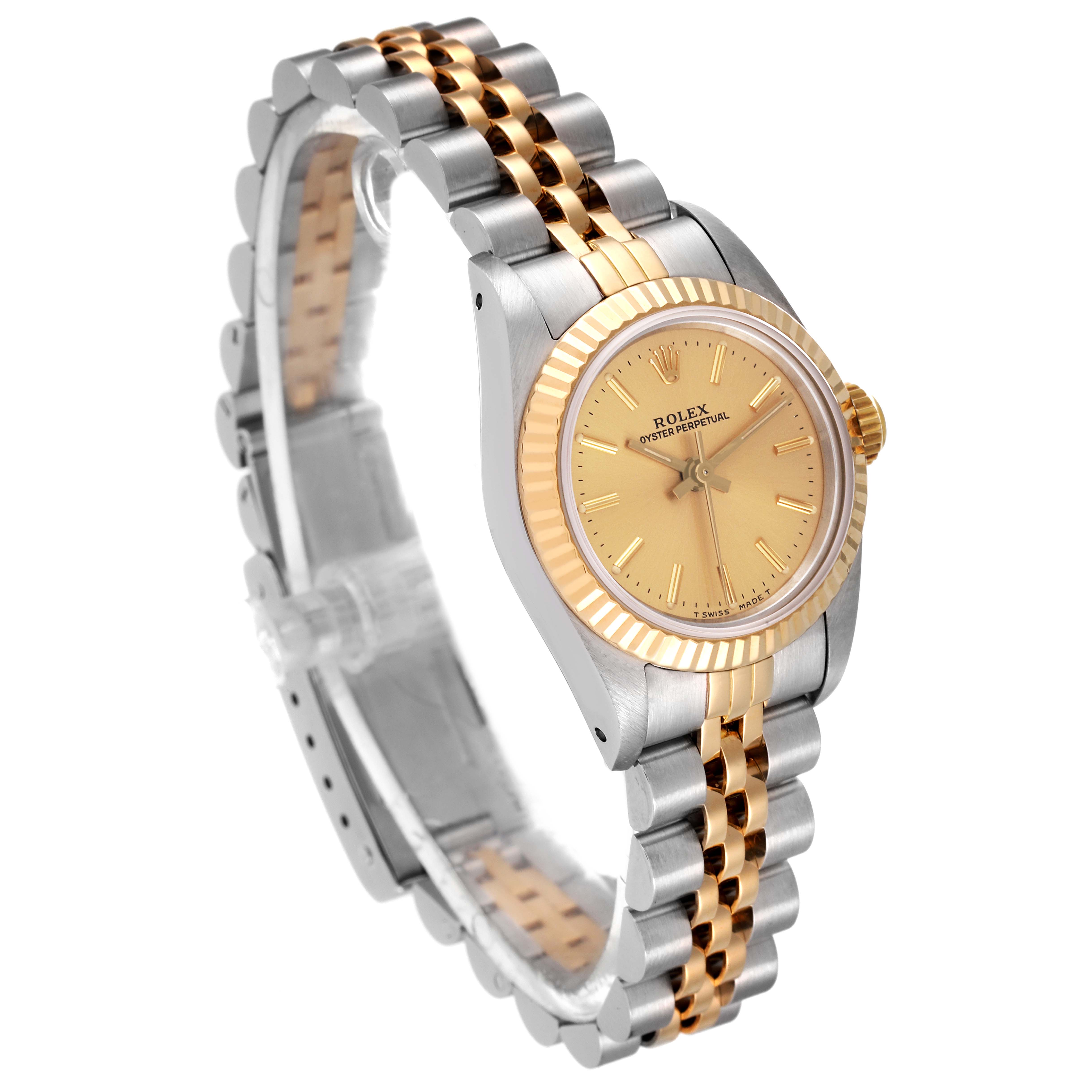 The Rolex Oyster Perpetual 67193 Women's Steel and Gold (two tone) Champagne Dial 67193 Women's Steel and Gold (two tone) Champagne Dial watch is shown at a slight angle, displaying its gold dial, fluted bezel, and two-tone metal bracelet.