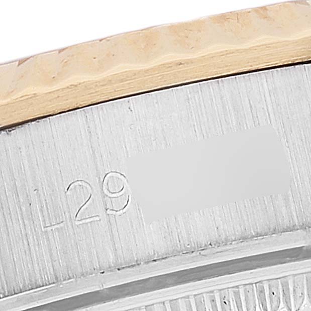 This is a close-up angle of the side of an Oyster Perpetual Rolex watch, showing the serial number engraving.