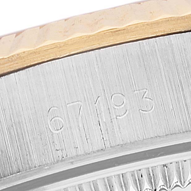The image shows a close-up of the side of a Rolex Oyster Perpetual 67193 Women's Steel and Gold (two tone) Champagne Dial 67193 Women's Steel and Gold (two tone) Champagne Dial watch, revealing part of its bezel and model number "67193."