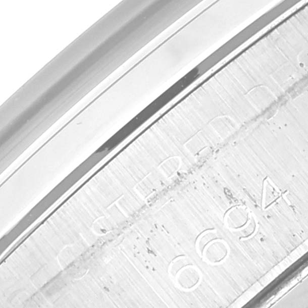 This image shows a close-up of the engraved case back of a Rolex Vintage Collection 6694 Men's Stainless Steel Silver Dial 6694 Men's Stainless Steel Silver Dial model watch.