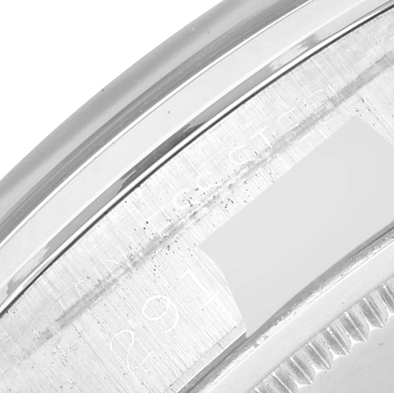 This close-up image of a Rolex Vintage Collection 6694 Men's Stainless Steel Silver Dial 6694 Men's Stainless Steel Silver Dial model shows part of the watch case with engraved text.