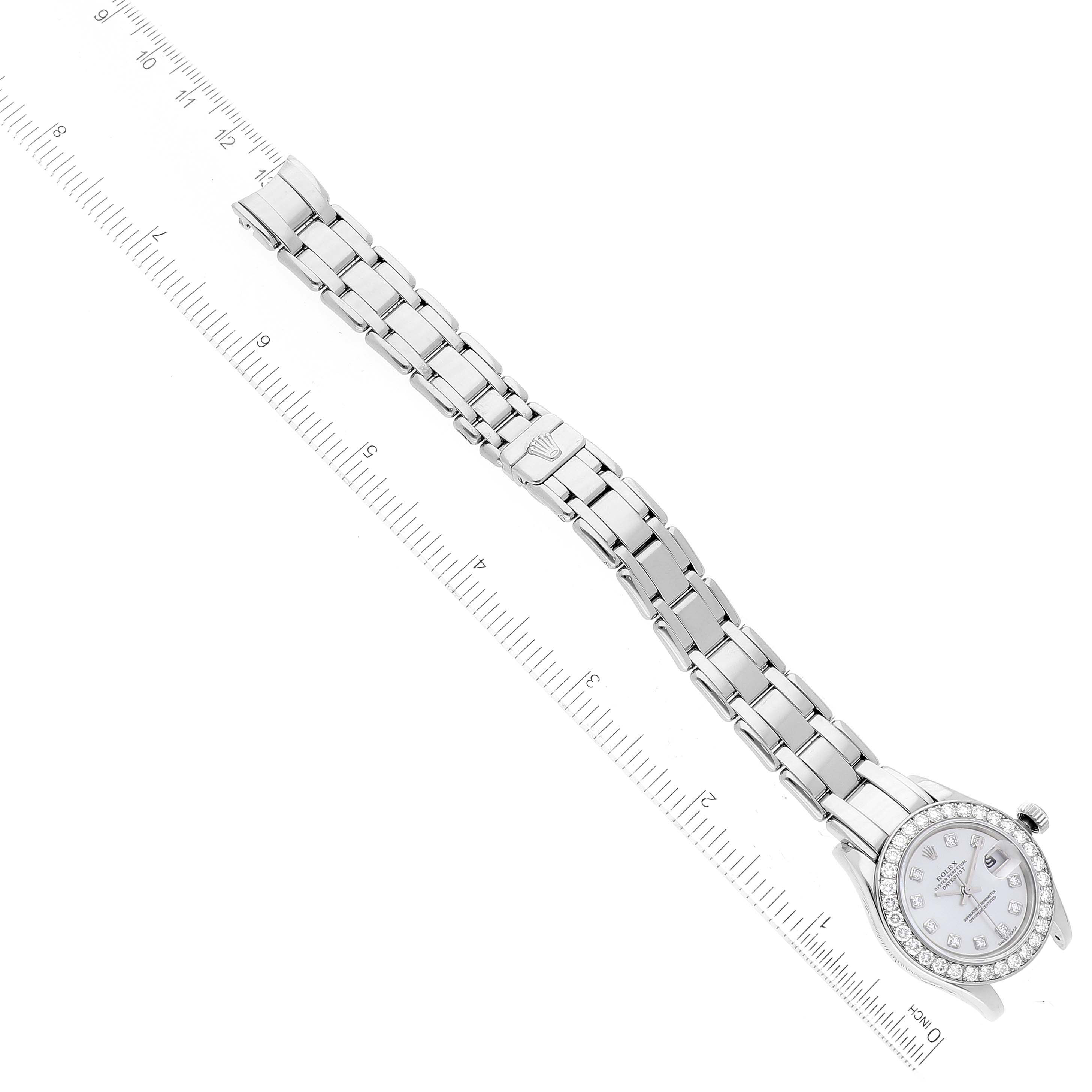 This image shows the Rolex Pearlmaster 69299 Women's White Gold Mother of Pearl Dial 69299 Women's White Gold Mother of Pearl Dial watch laid flat next to a measuring ruler, displaying both the face and the full bracelet.