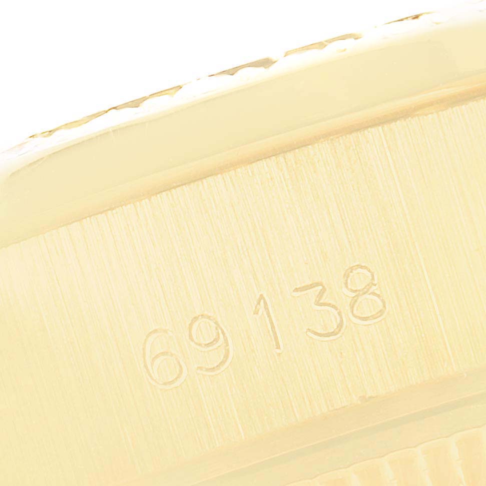 This close-up image shows the serial number engraved on the side of a Rolex President 69138 Women
s Yellow Gold Champagne Dial 69138 Women
s Yellow Gold Champagne Dial model watch.