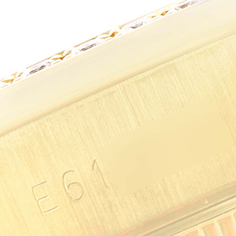 This image shows a close-up of the side of a Rolex President 69138 Women
s Yellow Gold Champagne Dial 69138 Women
s Yellow Gold Champagne Dial model watch, highlighting part of its band and engraved serial number.