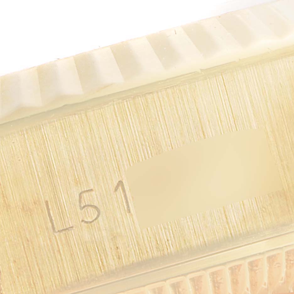 The image shows a close-up view of the side of a Rolex President 69178 Women
s Yellow Gold Champagne Dial 69178 Women
s Yellow Gold Champagne Dial model, highlighting the engraved serial number area.