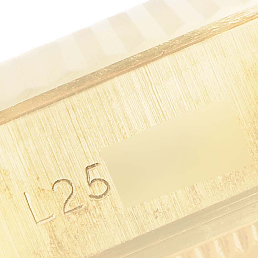 The image shows a close-up of the case and bezel of a Rolex President 69178 Women
s Yellow Gold Champagne Dial 69178 Women
s Yellow Gold Champagne Dial watch, featuring a fluted bezel and engraved details.