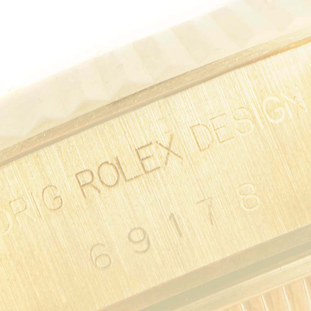 This image shows a close-up of the engraving on the side of a Rolex President 69178 Women
s Yellow Gold Mother of Pearl Dial 69178 Women
s Yellow Gold Mother of Pearl Dial model watch case.