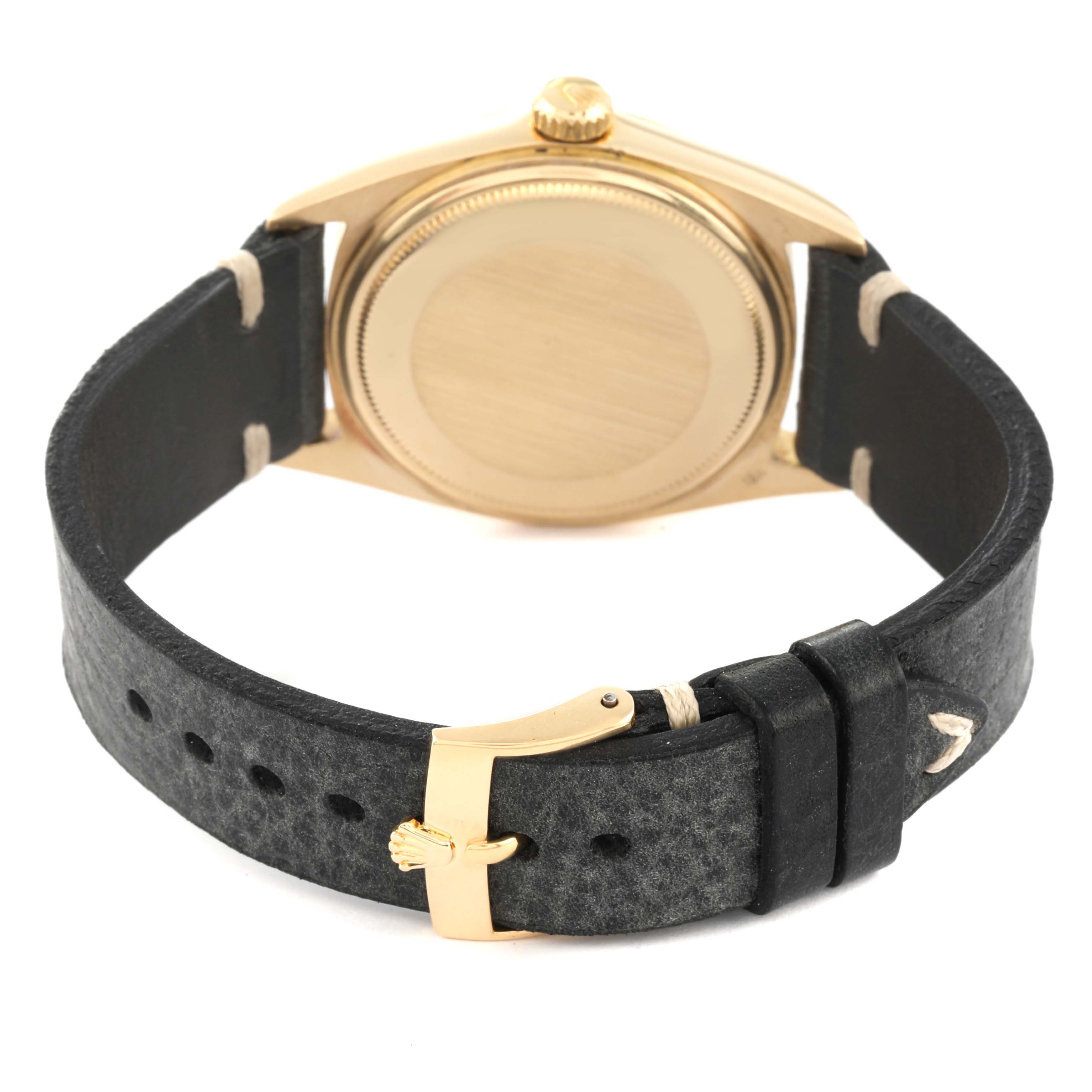 The image shows the back and side view of the Rolex Vintage Collection 1803 Men's Yellow Gold Champagne Dial 1803 Men's Yellow Gold Champagne Dial model with its gold case and black leather strap.