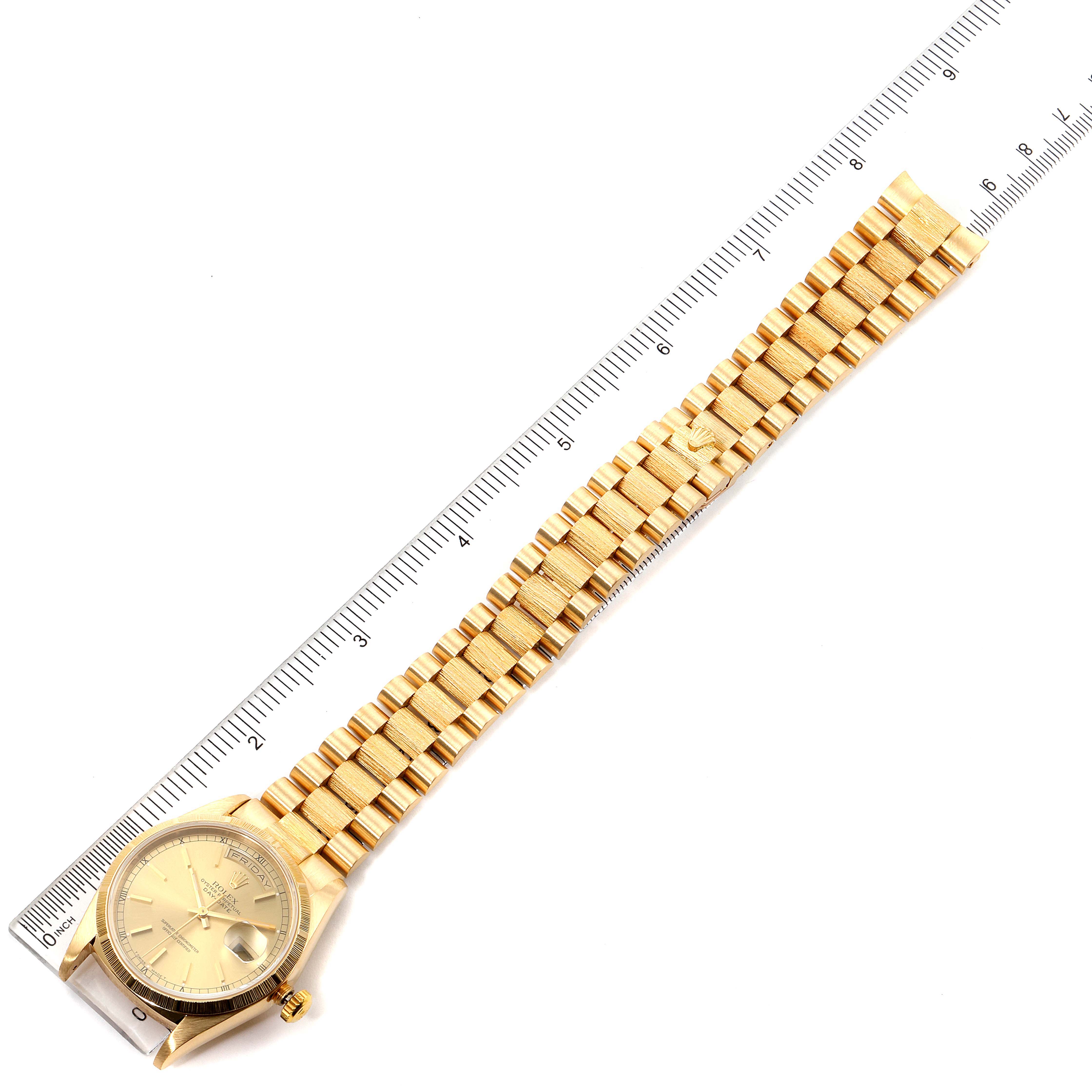 The image shows the Rolex President 18248 Men
s Yellow Gold Champagne Dial 18248 Men
s Yellow Gold Champagne Dial model watch laid flat with a ruler for scale, highlighting its gold band and face.