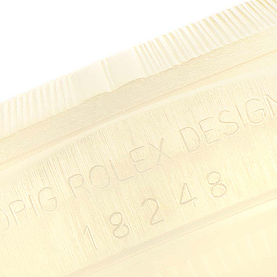The image shows the side engraving and textured edge of a Rolex President 18248 Men
s Yellow Gold Champagne Dial 18248 Men
s Yellow Gold Champagne Dial model watch.