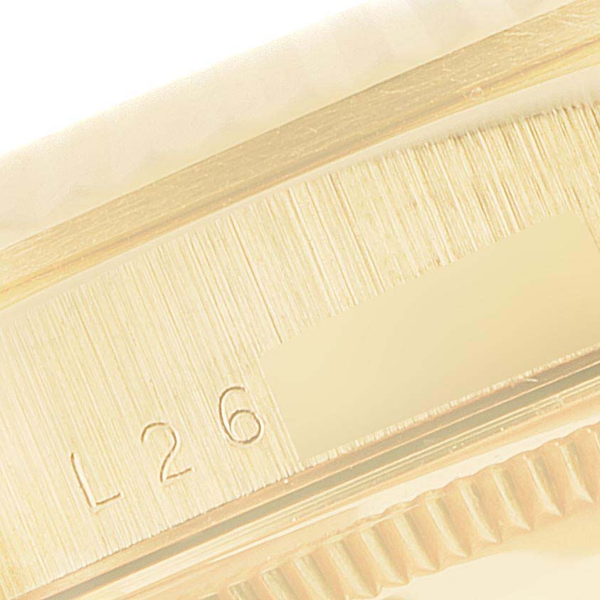 The image shows a close-up of the edge and engraved marking "L26" on a Rolex President 18238 Men
s Yellow Gold Champagne Dial 18238 Men
s Yellow Gold Champagne Dial model watch.