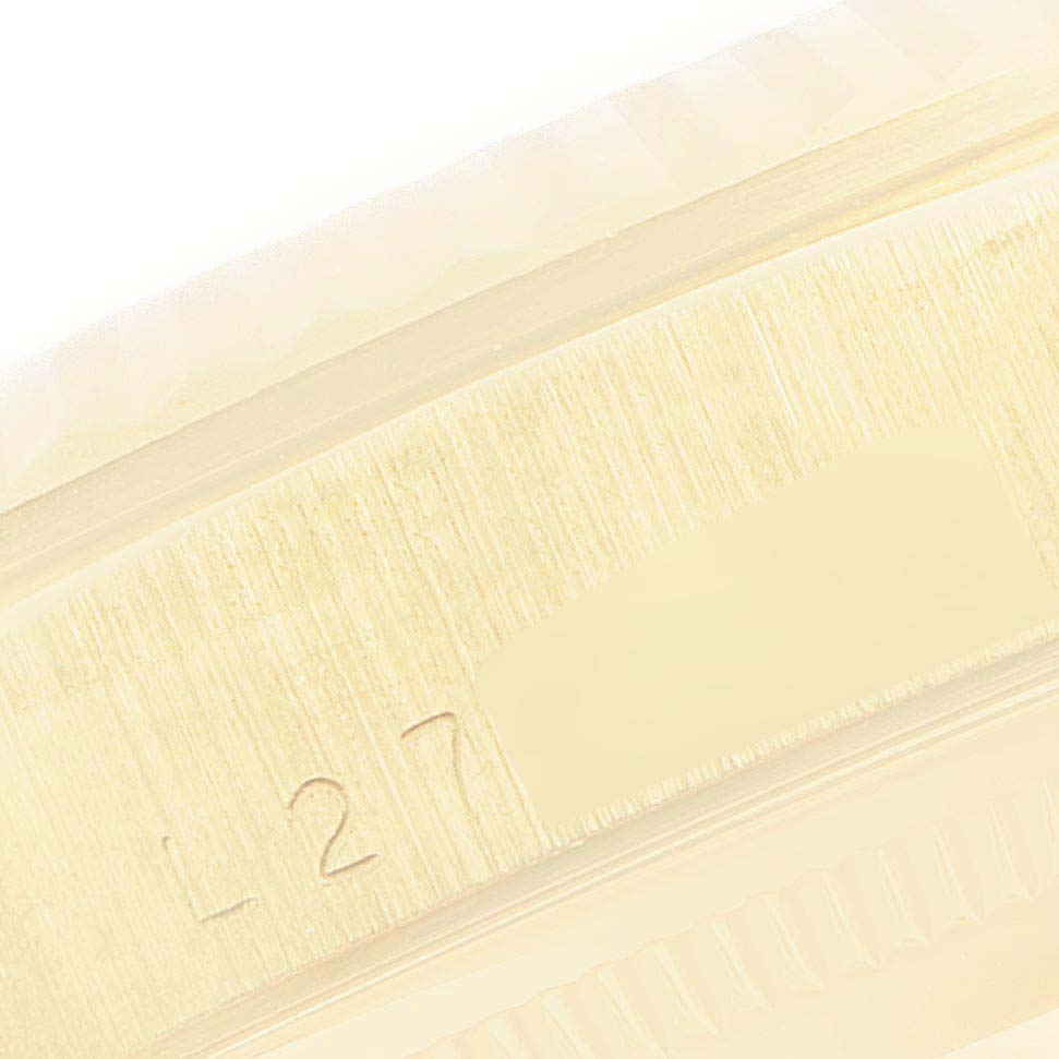 The image shows a close-up of the brushed metal surface and part of the bezel of the Rolex President 18238 Men's Yellow Gold Blue Dial 18238 Men's Yellow Gold Blue Dial model.