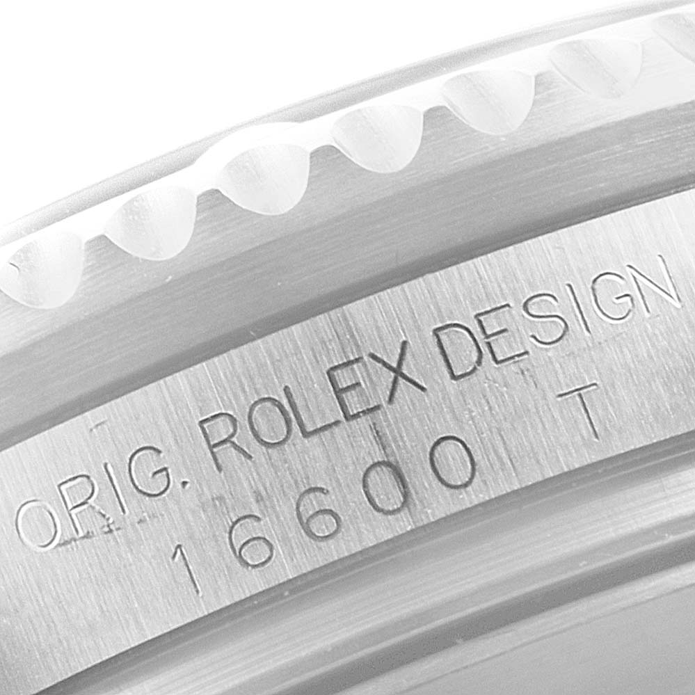 The image shows a close-up of the bezel and engraved case of a Rolex Sea-Dweller 16600 Men's Stainless Steel Black Dial 16600 Men's Stainless Steel Black Dial model watch.
