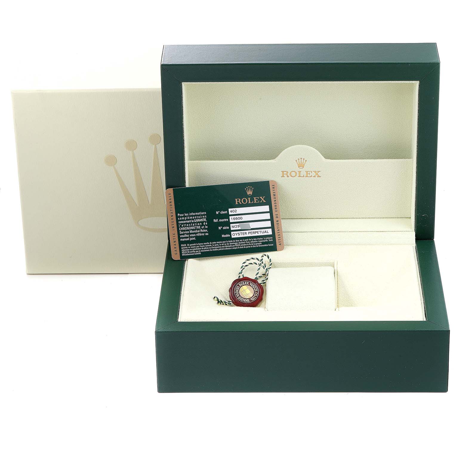 The image shows a green Rolex box for a Sea-Dweller model, containing the warranty card and seal tag.
