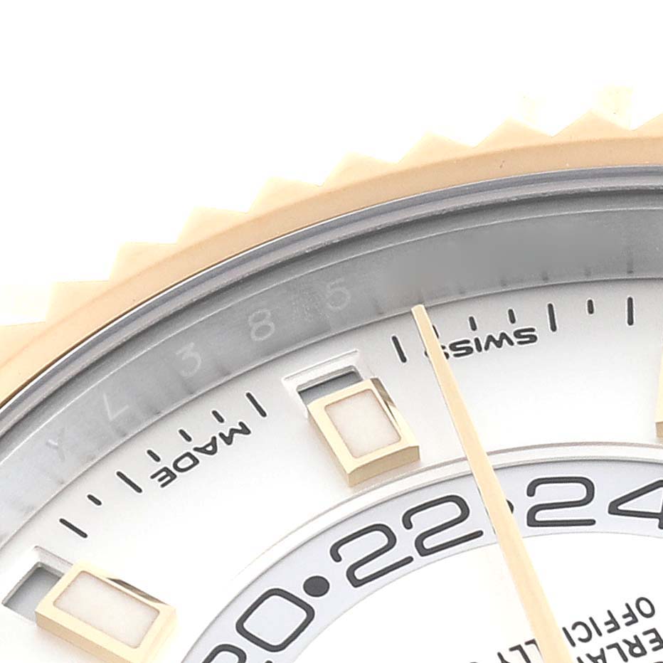 The image shows a close-up of the upper part of the dial and bezel of a Rolex Sky-Dweller 326933 Men
s Steel and Gold (two tone) White Dial 326933 Men
s Steel and Gold (two tone) White Dial watch.