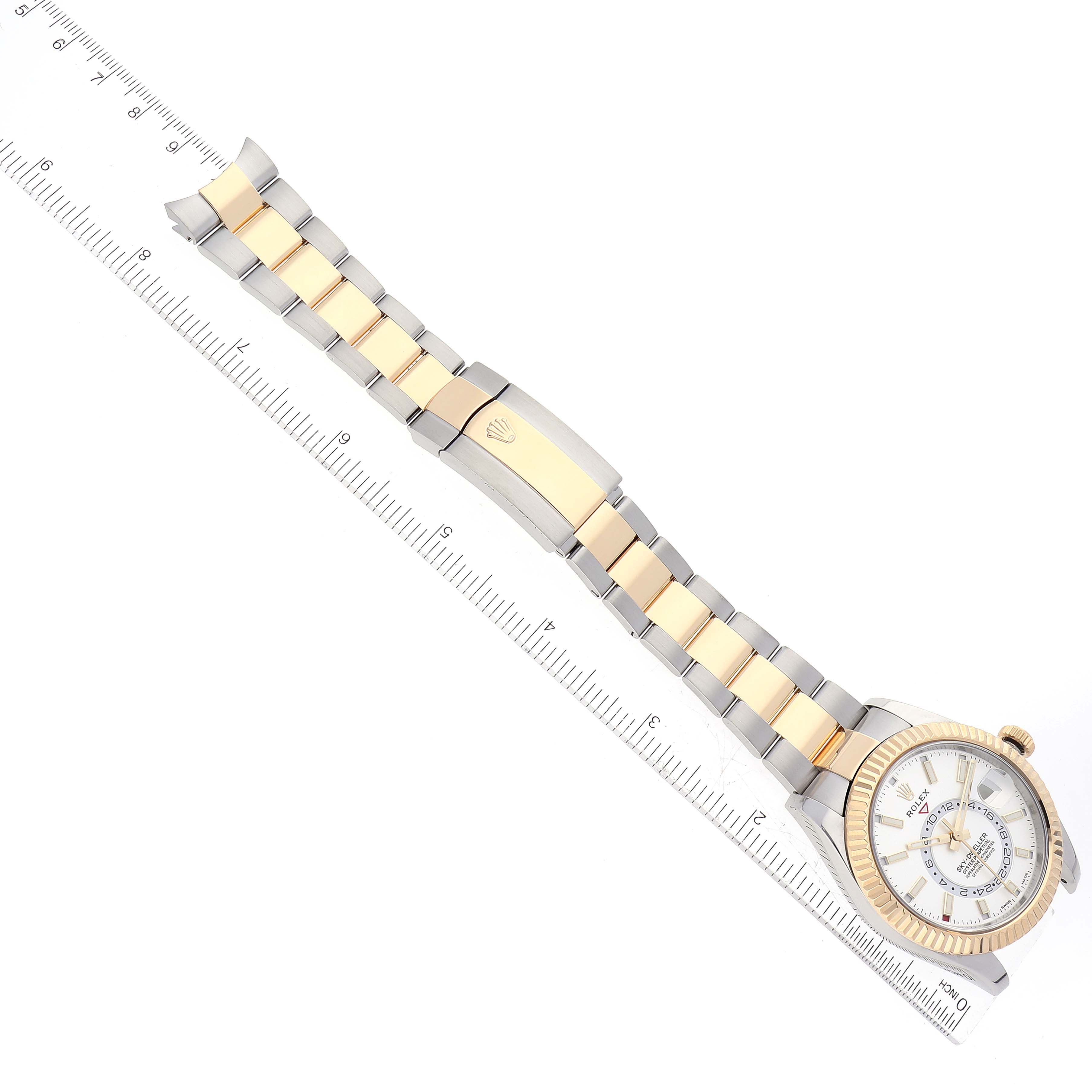 The image shows a top-down view of a Rolex Sky-Dweller 326933 Men
s Steel and Gold (two tone) White Dial 326933 Men
s Steel and Gold (two tone) White Dial watch, highlighting its two-tone bracelet and closed clasp.