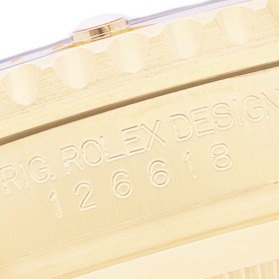 The image shows a close-up of the side of a Rolex Submariner 126618 Men's Yellow Gold Blue Dial 126618 Men's Yellow Gold Blue Dial watch, including the bezel edge and part of the engraved case.