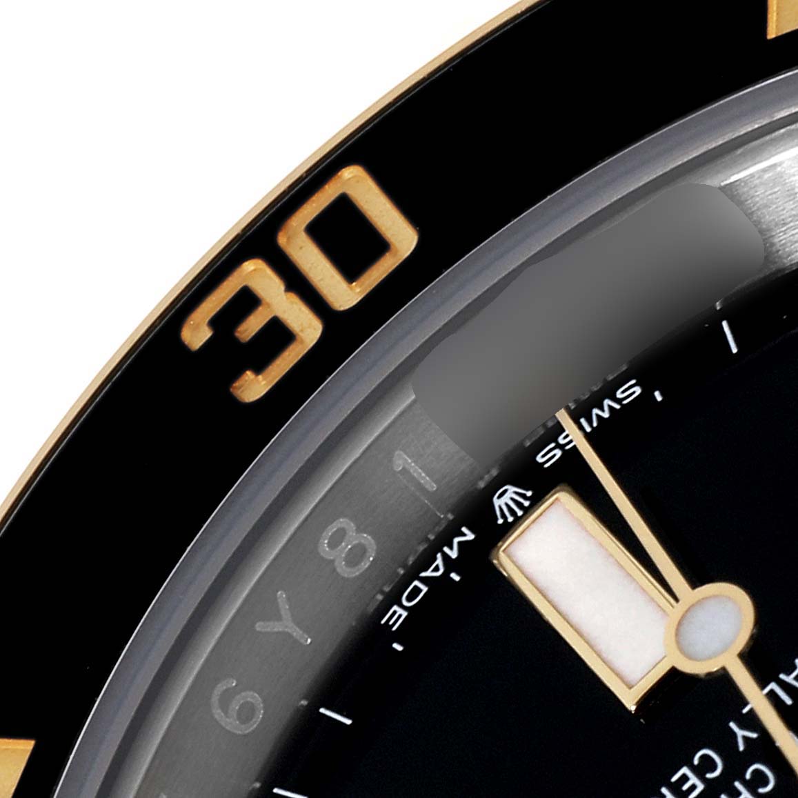 This close-up image shows the bezel and part of the dial of a Rolex Submariner 126613 Men's Steel and Gold (two tone) Black Dial 126613 Men's Steel and Gold (two tone) Black Dial watch.
