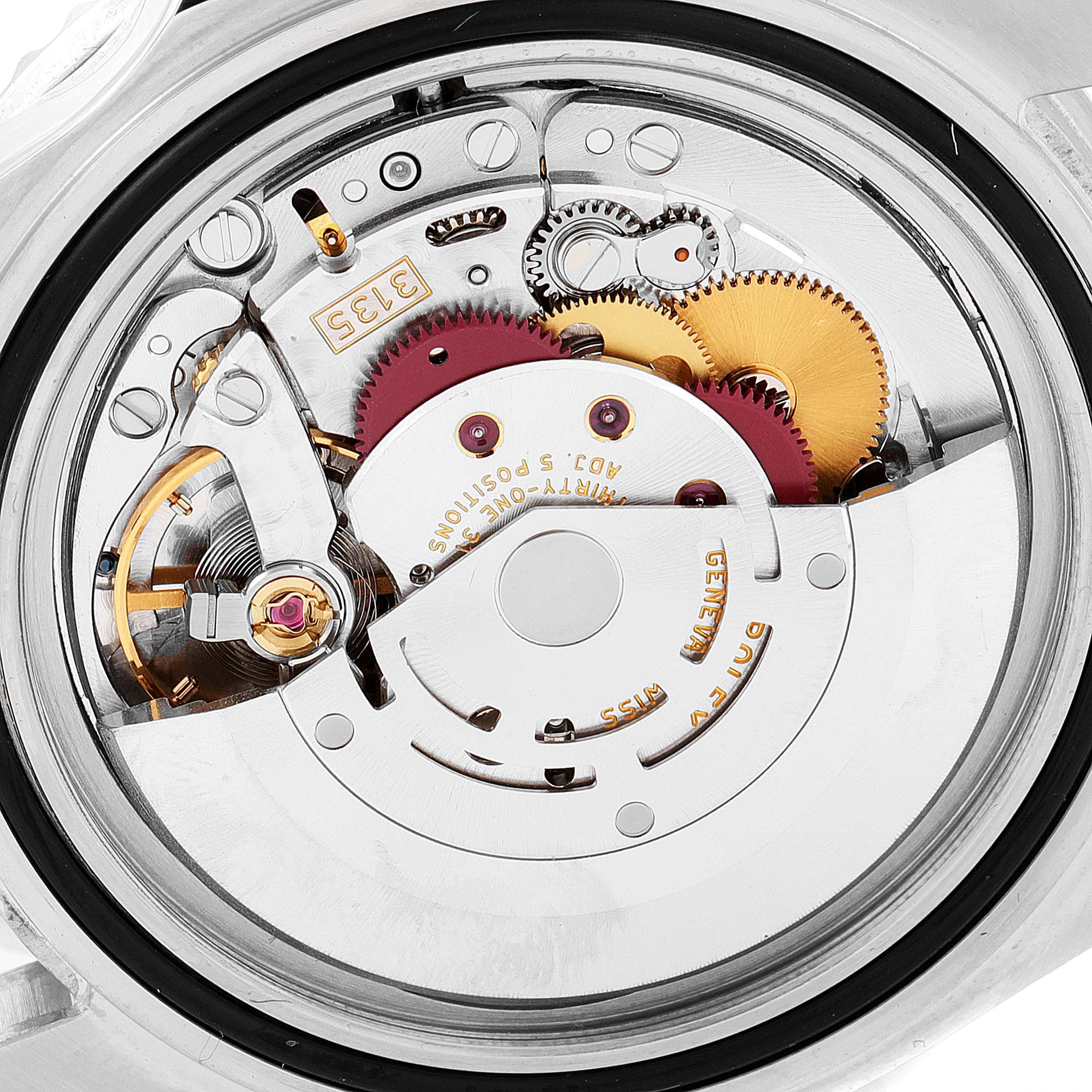 The image shows a close-up view of the movement inside a Rolex Submariner 16610 Men
s Stainless Steel Black Dial 16610 Men
s Stainless Steel Black Dial watch, highlighting its intricate gears and components.