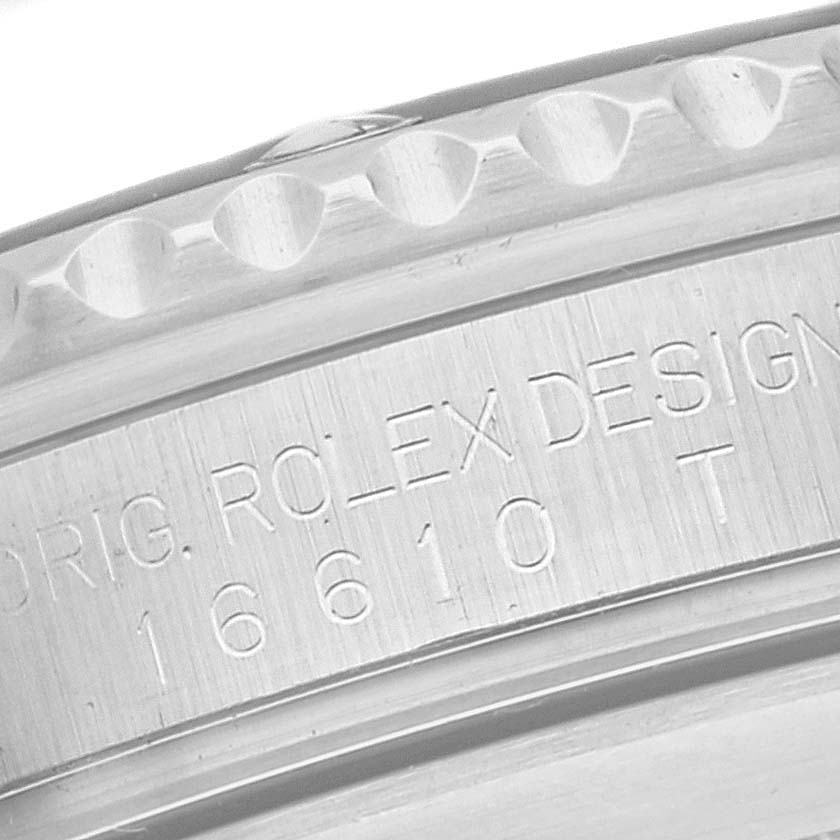 The image shows a close-up of the engraving and bezel of a Rolex Submariner 16610 Men
s Stainless Steel Black Dial 16610 Men
s Stainless Steel Black Dial watch.