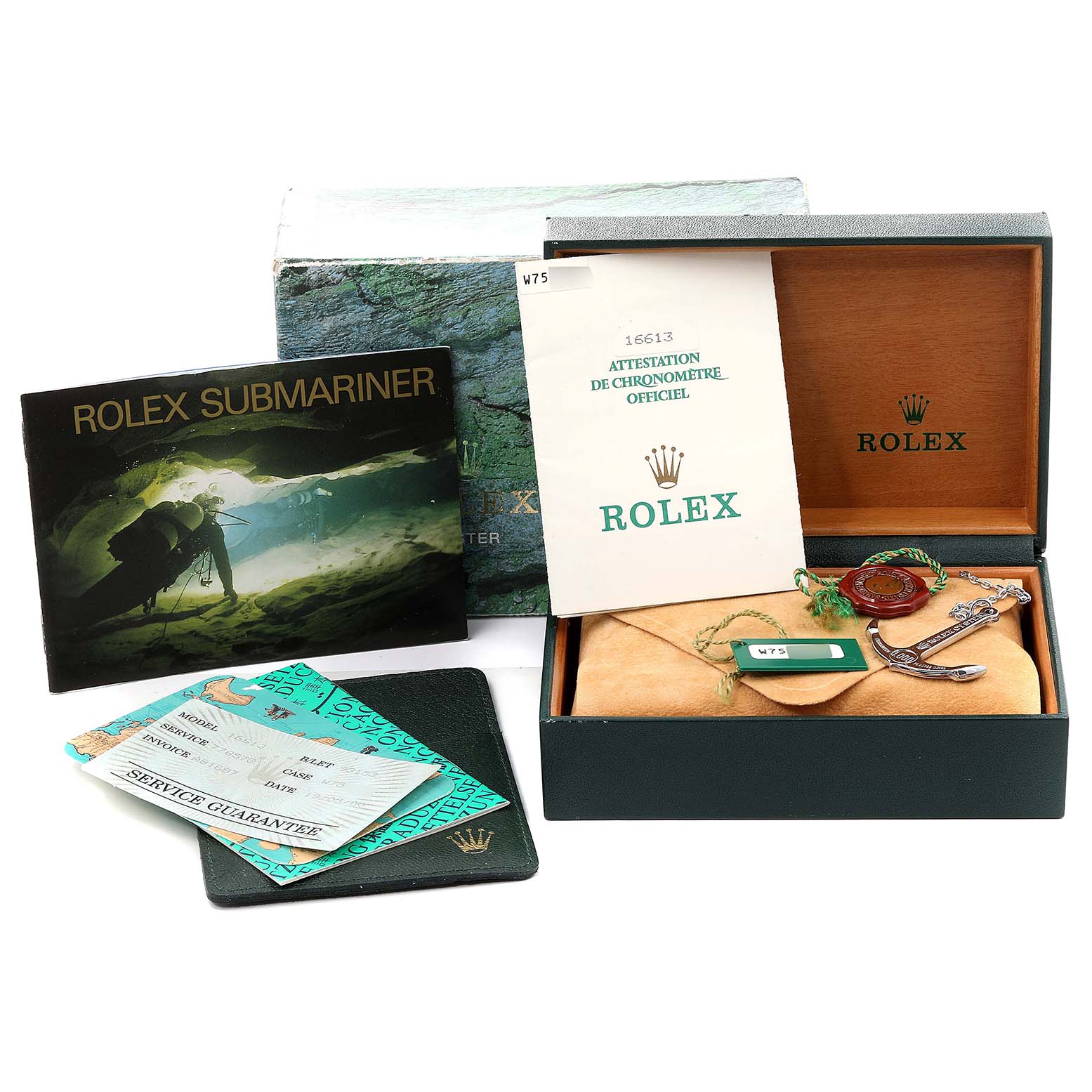 The image shows a Rolex Submariner 16613 Men's Steel and Gold (two tone) Blue Dial 16613 Men's Steel and Gold (two tone) Blue Dial packaging including the box, warranty papers, booklets, and tags from a top view.