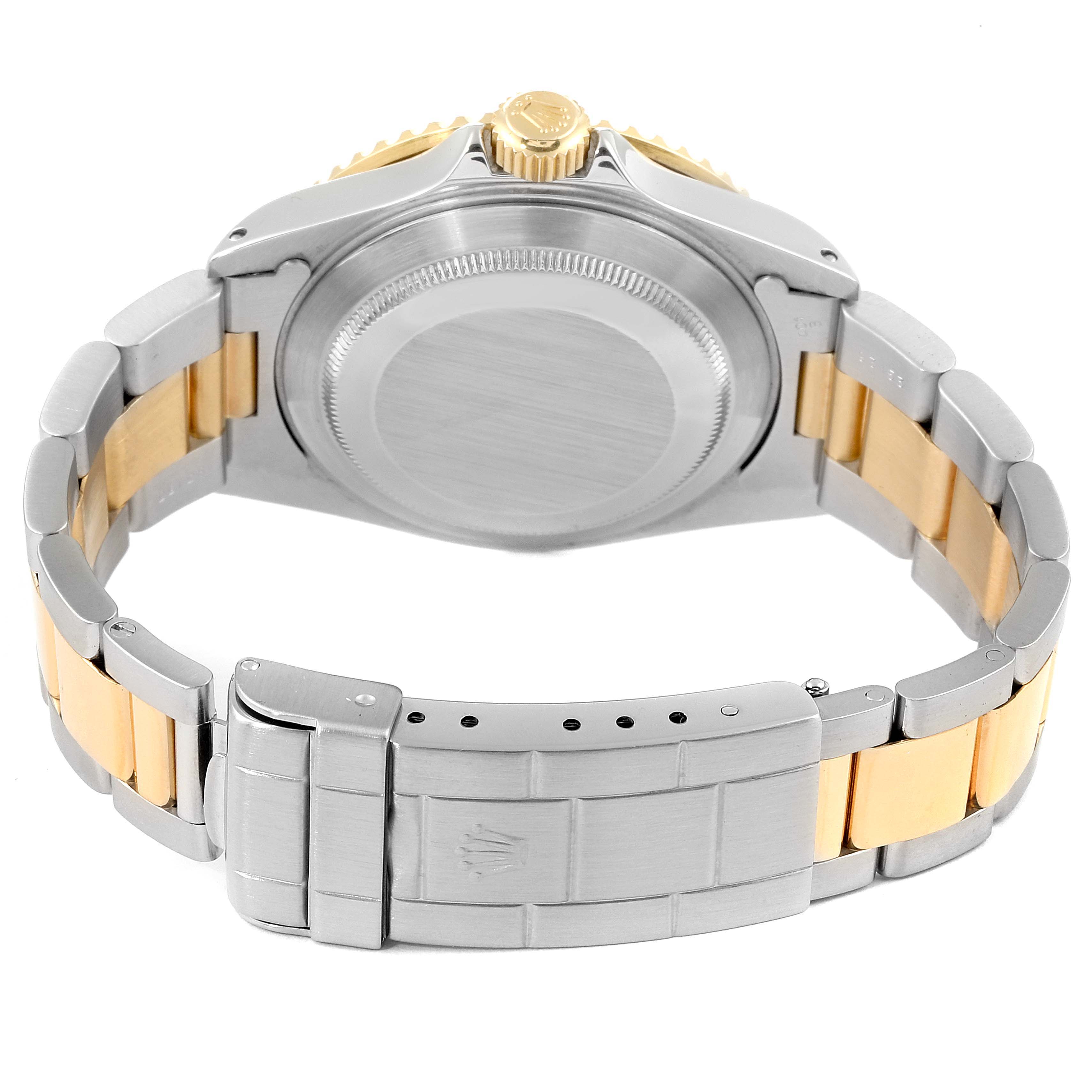 The image shows the back view of a Rolex Submariner 16613 Men's Steel and Gold (two tone) Blue Dial 16613 Men's Steel and Gold (two tone) Blue Dial watch, highlighting the case back, crown, and two-tone bracelet.