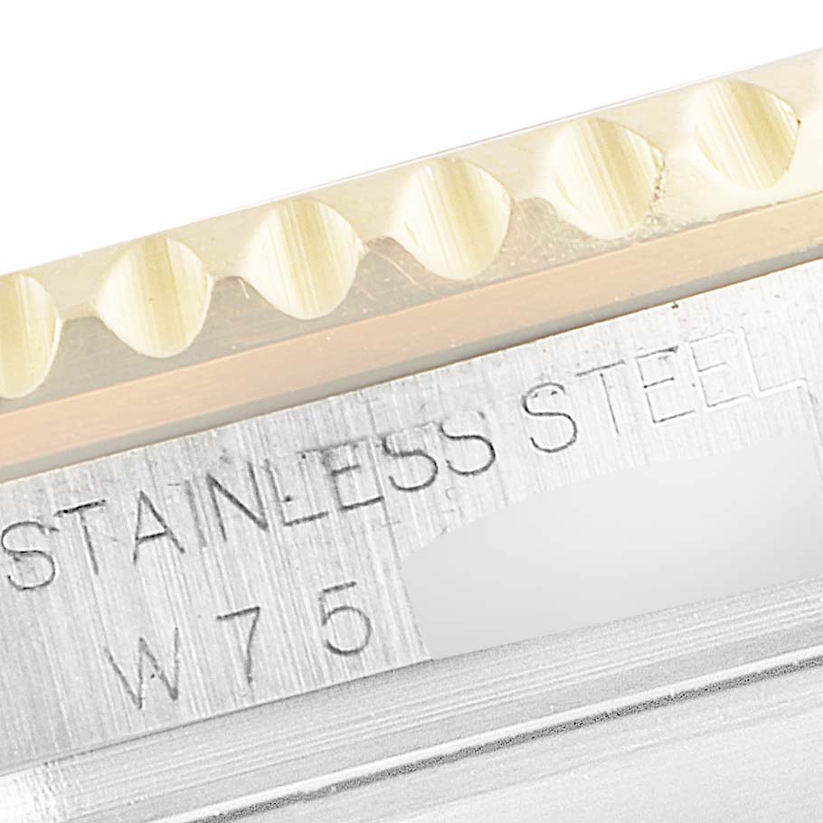 The image shows a close-up of the side of a Rolex Submariner 16613 Men's Steel and Gold (two tone) Blue Dial 16613 Men's Steel and Gold (two tone) Blue Dial watch, featuring "Stainless Steel" engraving and part of the bezel.