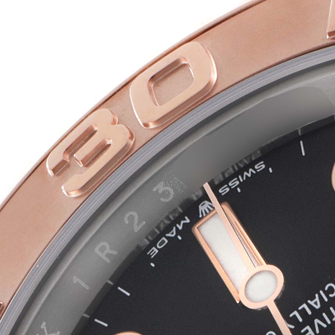 This close-up image of the Rolex Yacht-Master 126621 Men's Steel and Gold (two tone) Black Dial 126621 Men's Steel and Gold (two tone) Black Dial watch shows the bezel with the "30" marking and a portion of the dial with the minute hand.