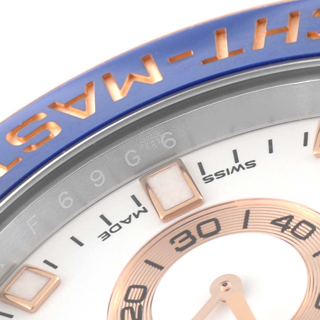 This close-up image shows part of the dial and bezel of a Rolex Yacht-Master 116681 Men's Steel and Gold (two tone) White Dial 116681 Men's Steel and Gold (two tone) White Dial watch, highlighting the "MASTER" text and Swiss made mark.
