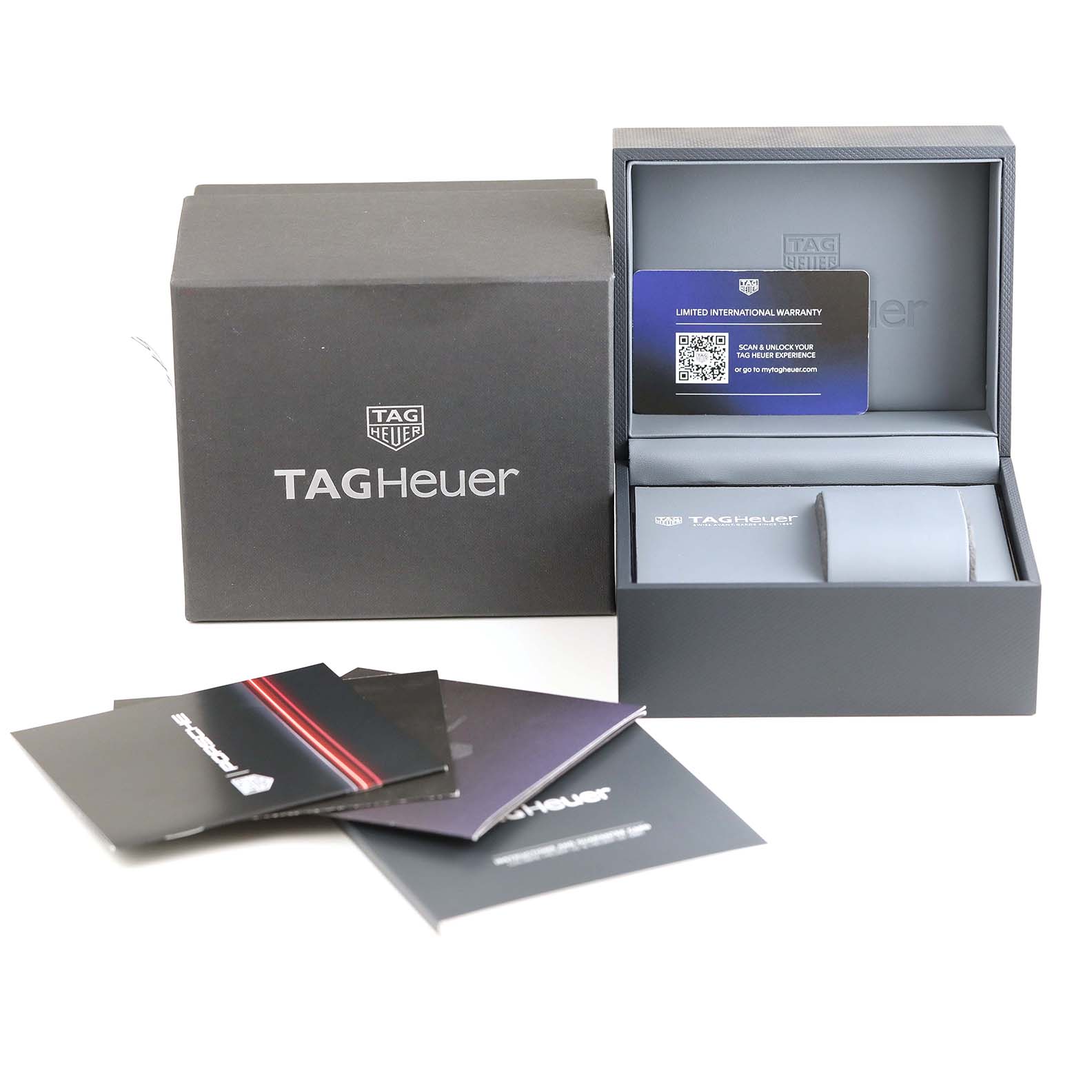 The image shows a Tag Heuer Carrera CBN2A1F.BA0643 Men's Stainless Steel Grey Dial CBN2A1F.BA0643 Men's Stainless Steel Grey Dial watch box, warranty card, and user manuals from a slightly elevated angle.