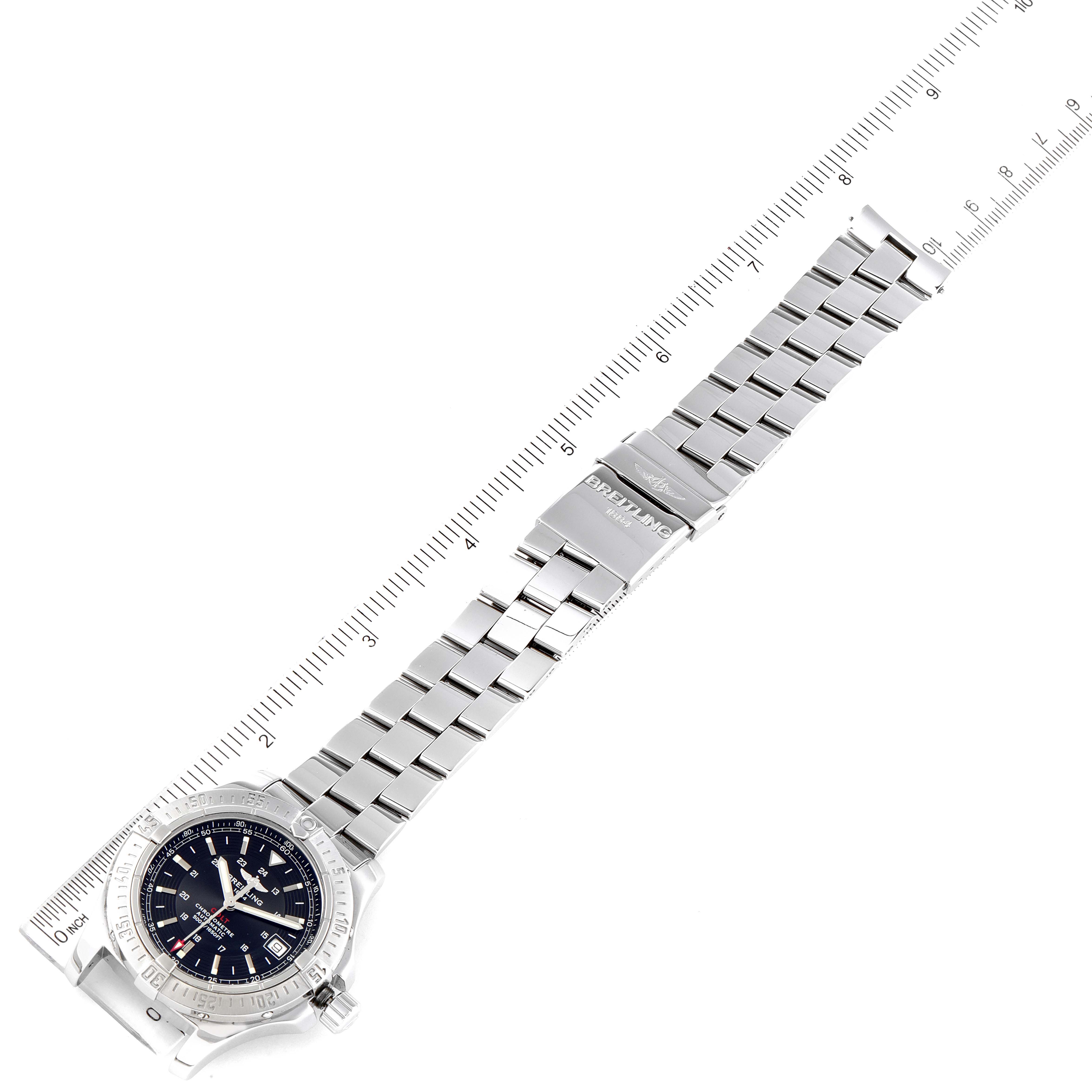 The image shows a top-down view of the Breitling Colt A17380 Men
s Stainless Steel Black Dial A17380 Men
s Stainless Steel Black Dial watch, displaying the face, bezel, and bracelet with a ruler next to it.