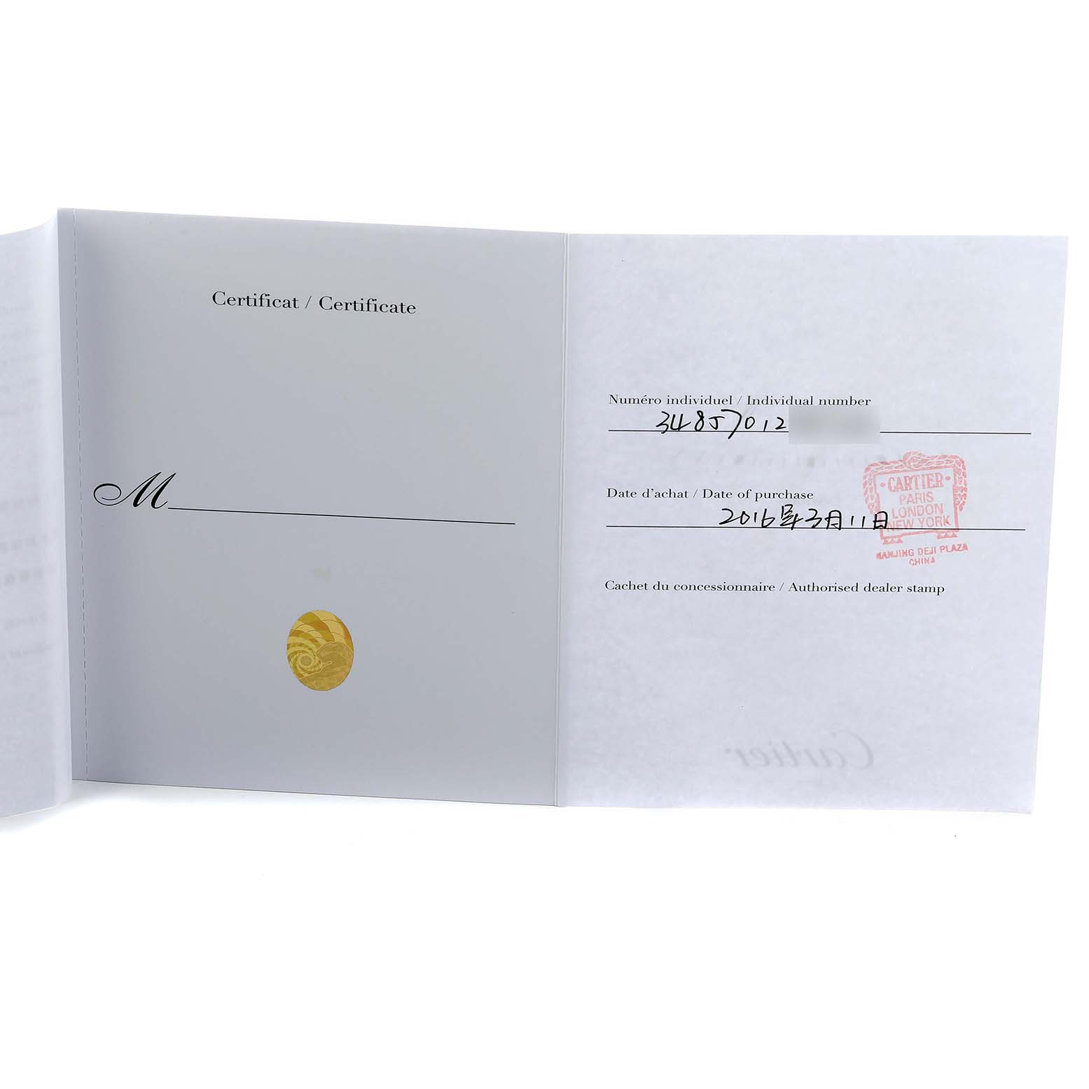 The image shows an open certificate with dealer stamp and details for a Cartier Tank Anglaise W5310022 Women's Stainless Steel Silver Dial watch.