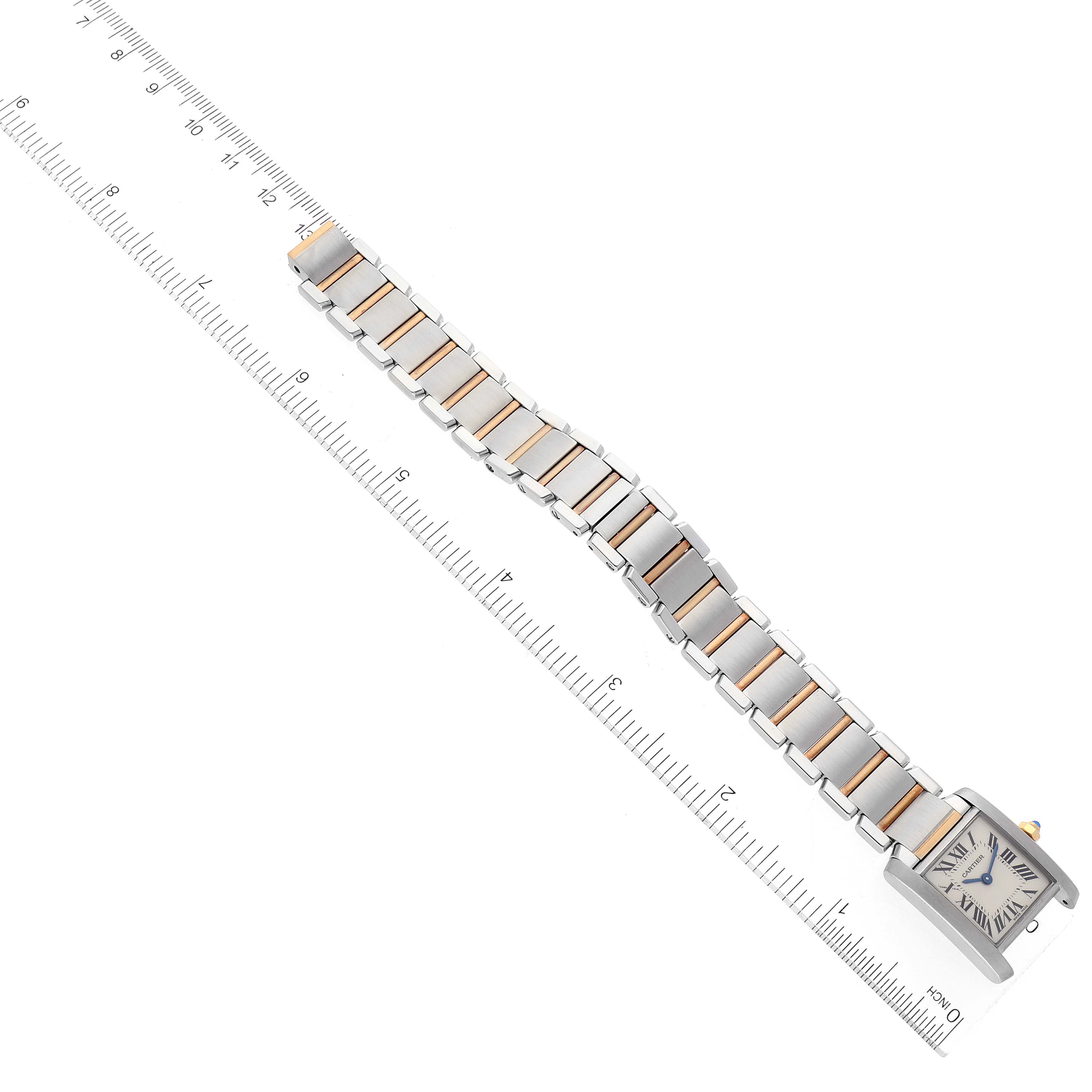 The Cartier Tank Francaise W51007Q4 Women's Steel and Gold (two tone) Silver Dial W51007Q4 Women's Steel and Gold (two tone) Silver Dial watch is shown from an overhead angle, displaying its face, bracelet, and part of the ruler for scale.
