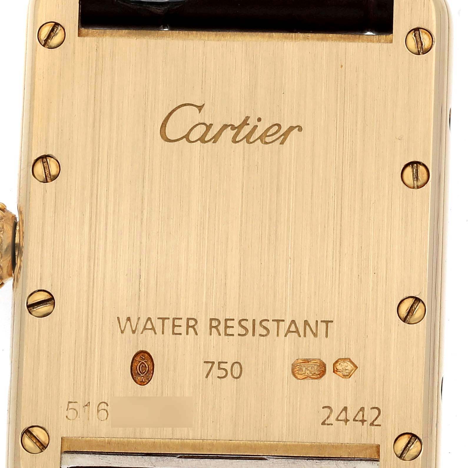 The image shows the back of a Cartier Tank Louis W1529856 Women's Yellow Gold Silver Dial watch, highlighting the brand engraving, screws, and hallmarks.