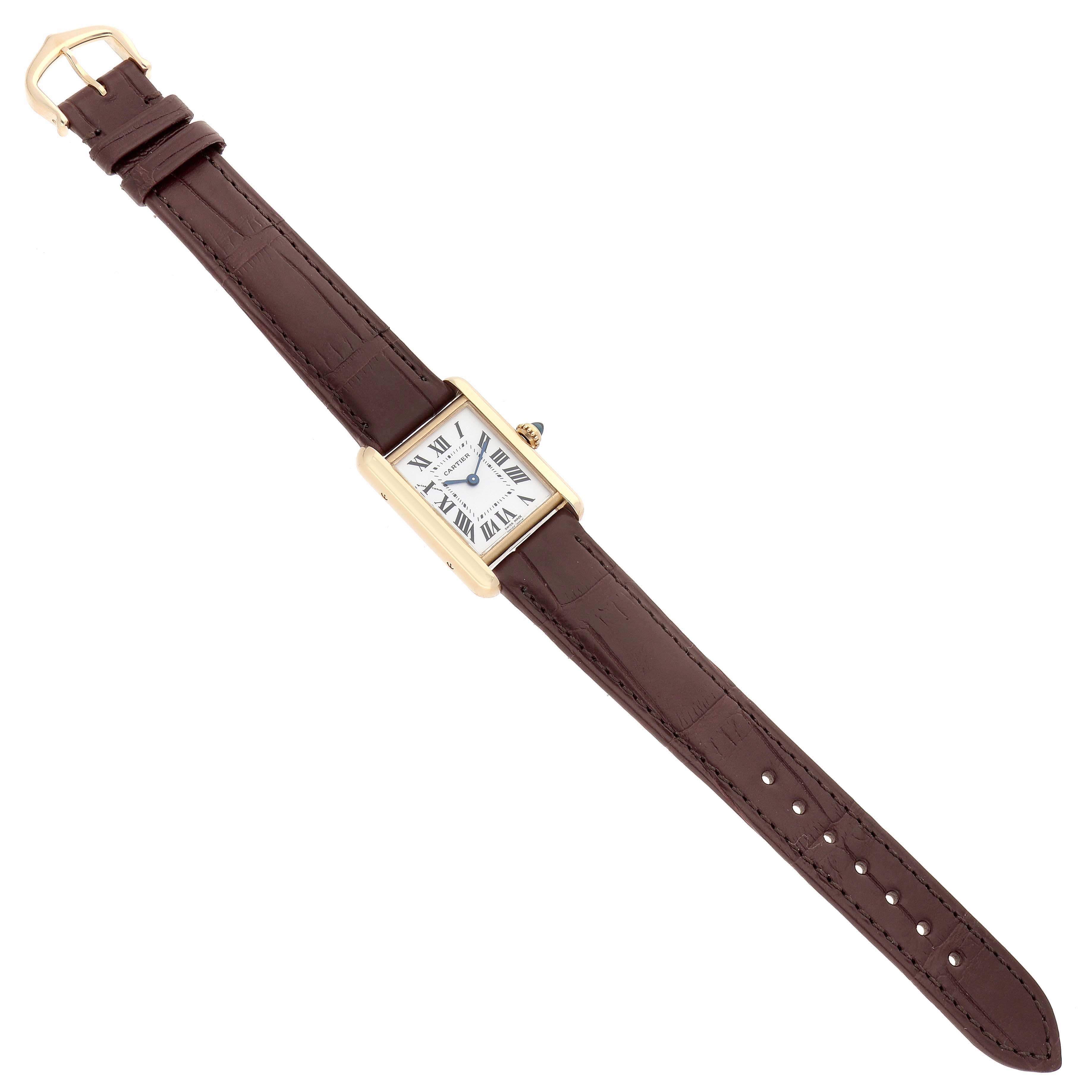 The Cartier Tank Louis W1529856 Women's Yellow Gold Silver Dial watch is shown from a top-down angle, displaying the face, brown leather strap, and gold case.
