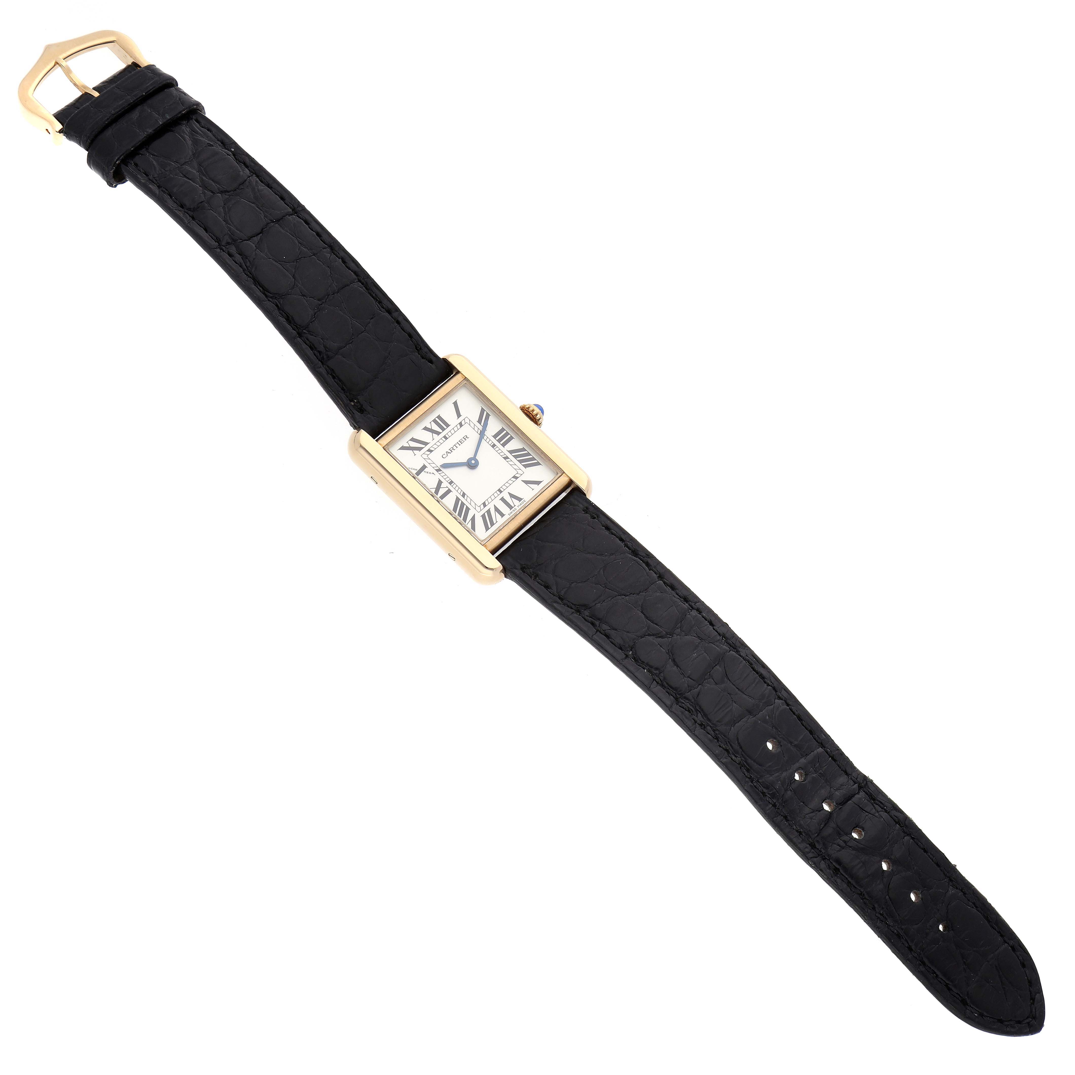 The Cartier Tank Solo W5200002 Women's Yellow Gold Silver Dial watch is shown from a top-down angle, displaying the face and full black leather strap.