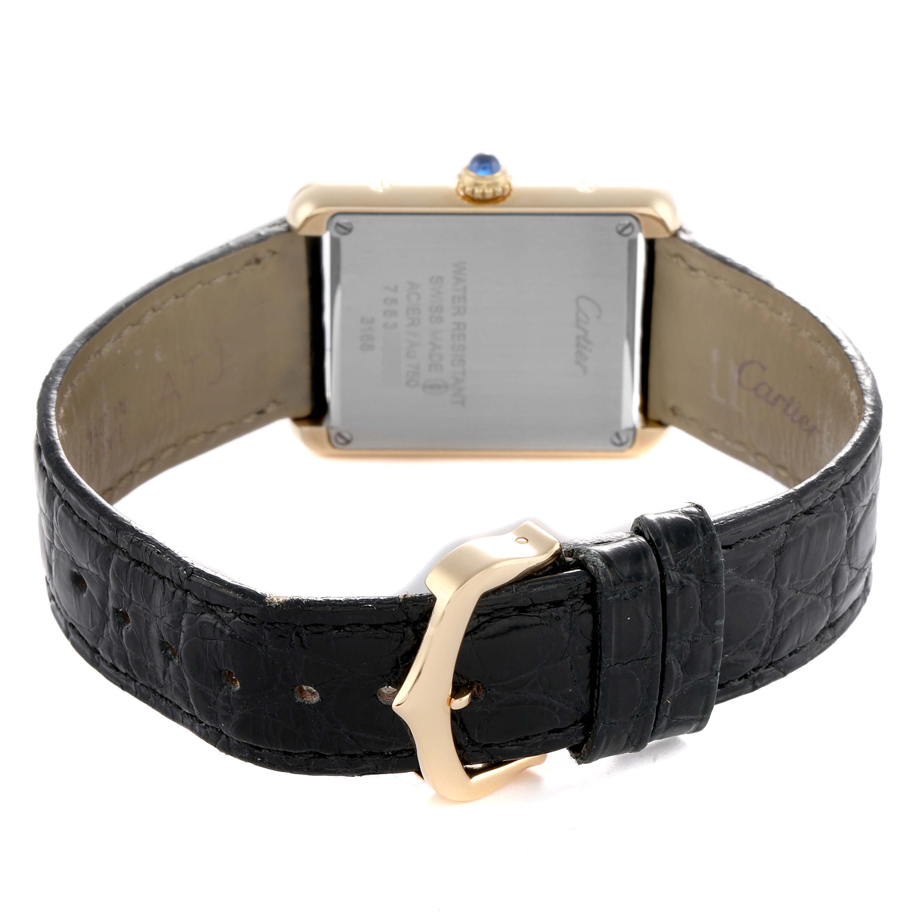 The image shows the back of a Cartier Tank Solo W5200002 Women's Yellow Gold Silver Dial watch, with its leather strap and the case back details clearly visible.