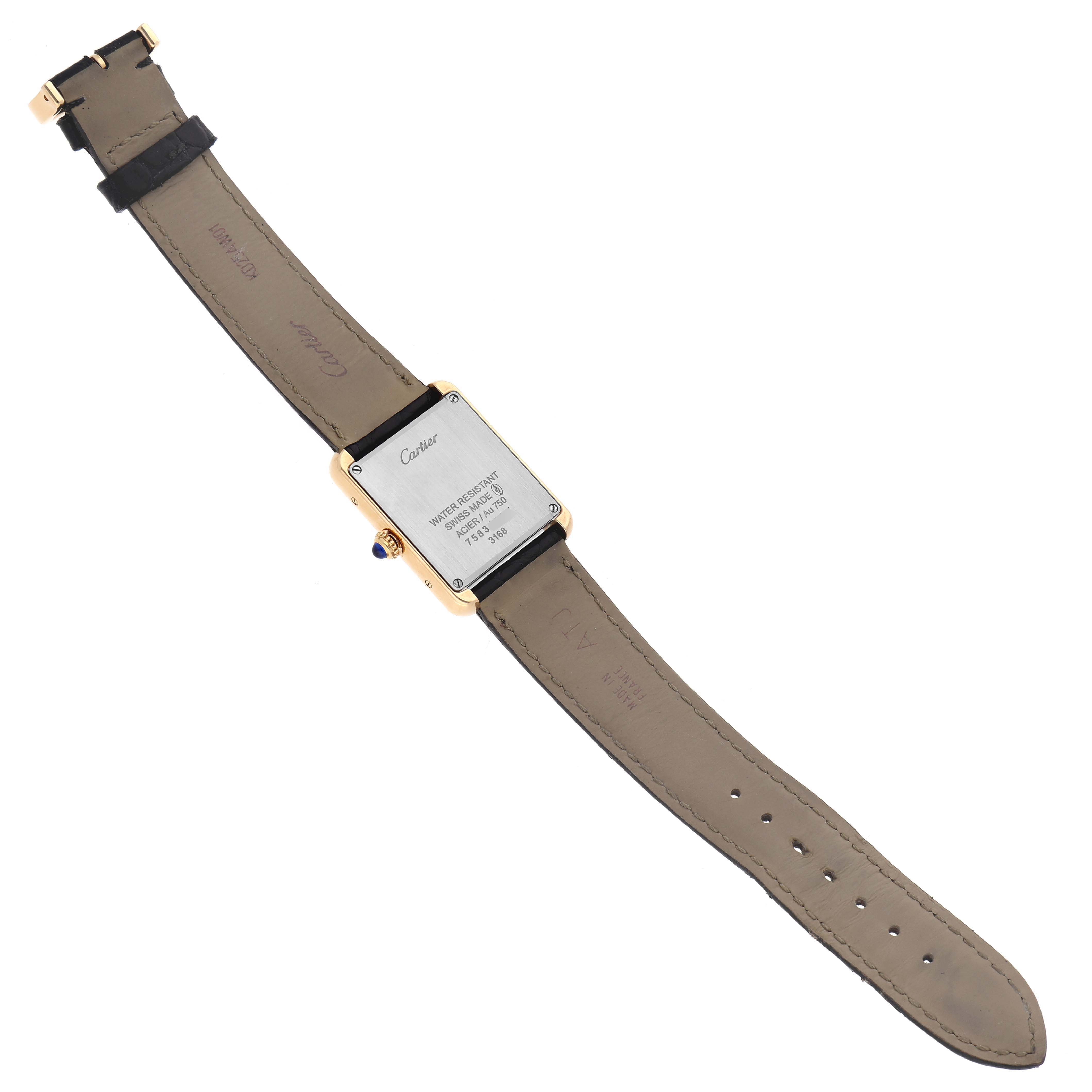 The image shows the back view of a Cartier Tank Solo W5200002 Women's Yellow Gold Silver Dial watch, highlighting the case back and leather strap.