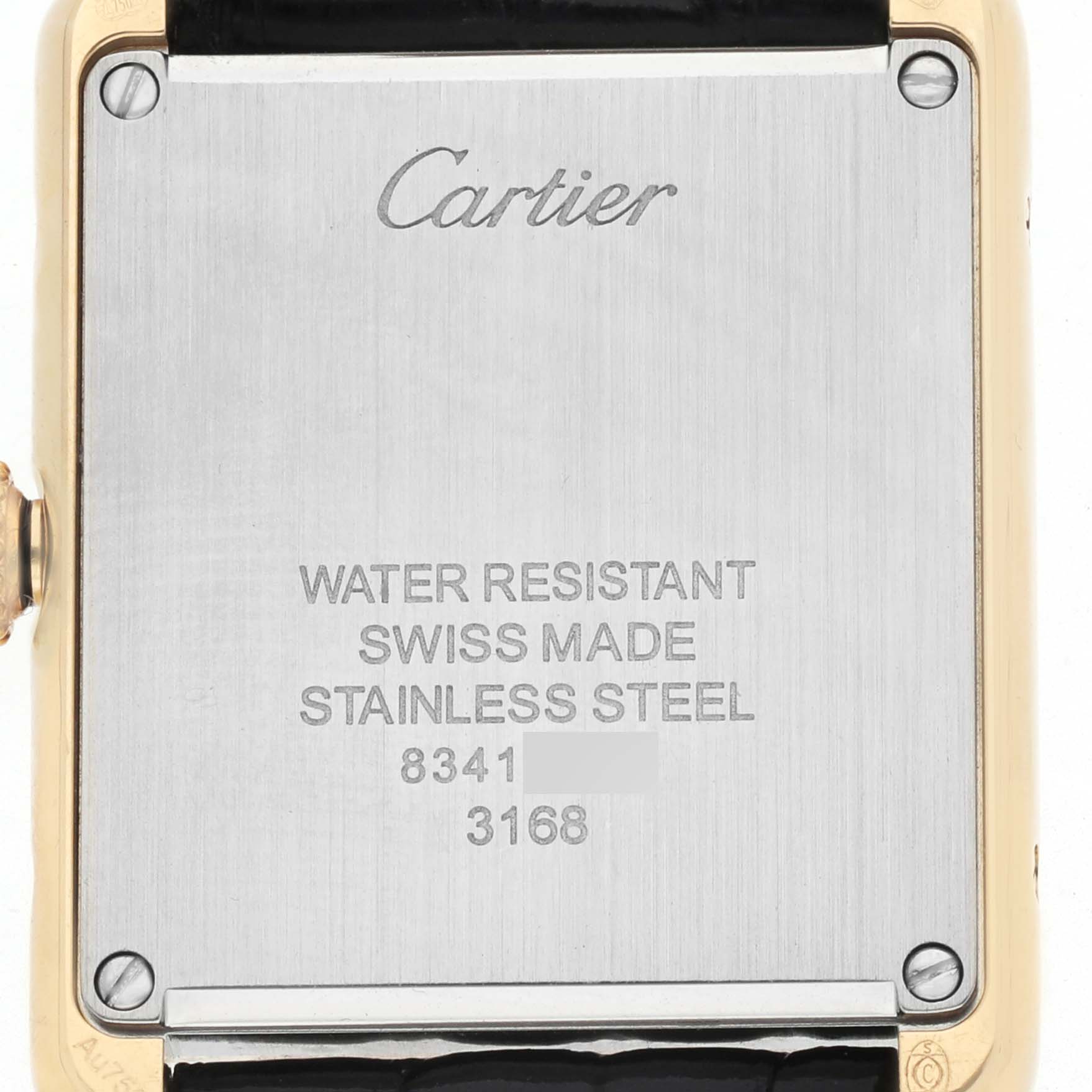 The image shows the back of a Cartier Tank Solo W5200002 Women's Yellow Gold Silver Dial watch, highlighting the engraved details and material.