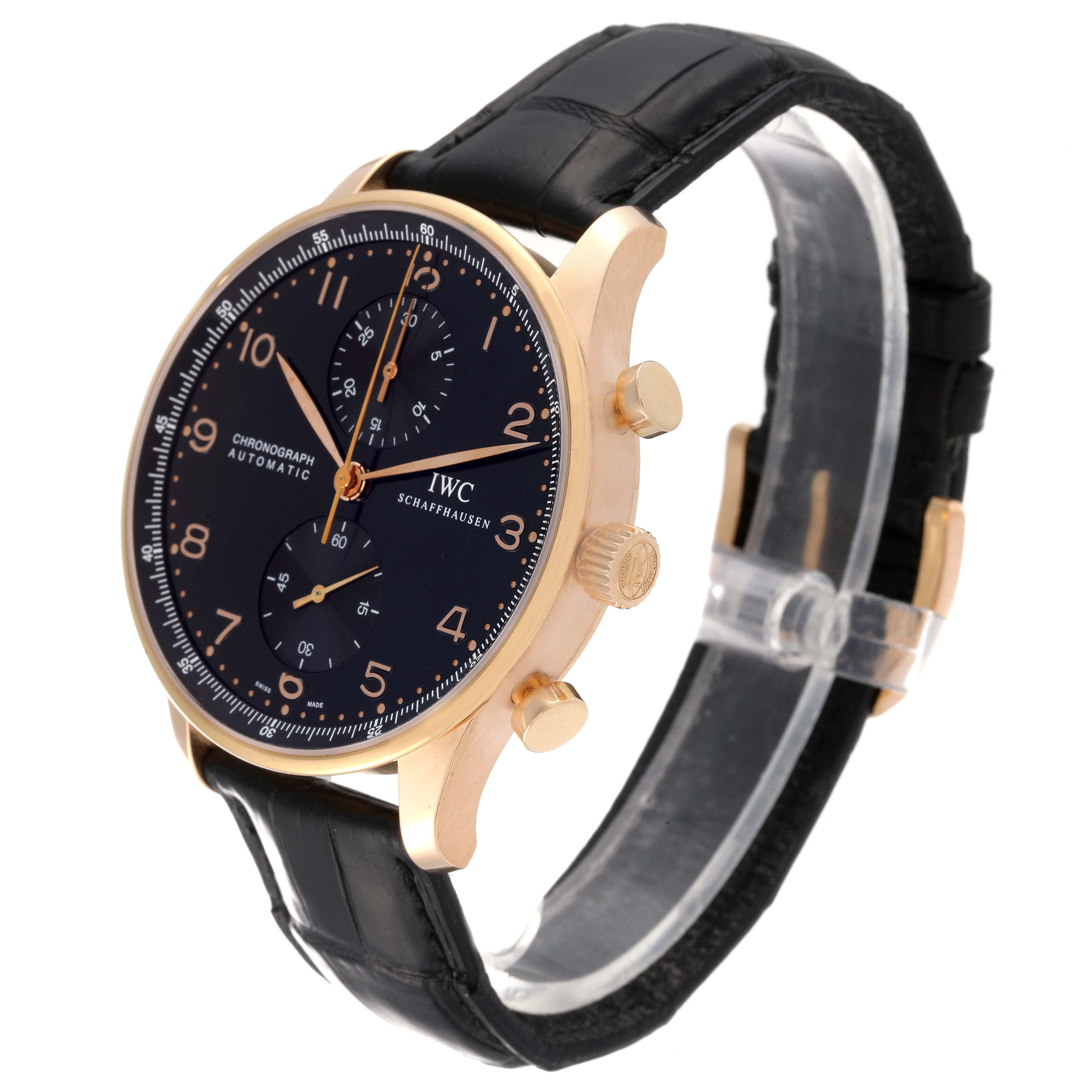 The IWC Portuguese IW371415 Men's Rose Gold Black Dial IW371415 Men's Rose Gold Black Dial model watch is shown at an angle displaying the face, crown, pushers, and black leather strap.