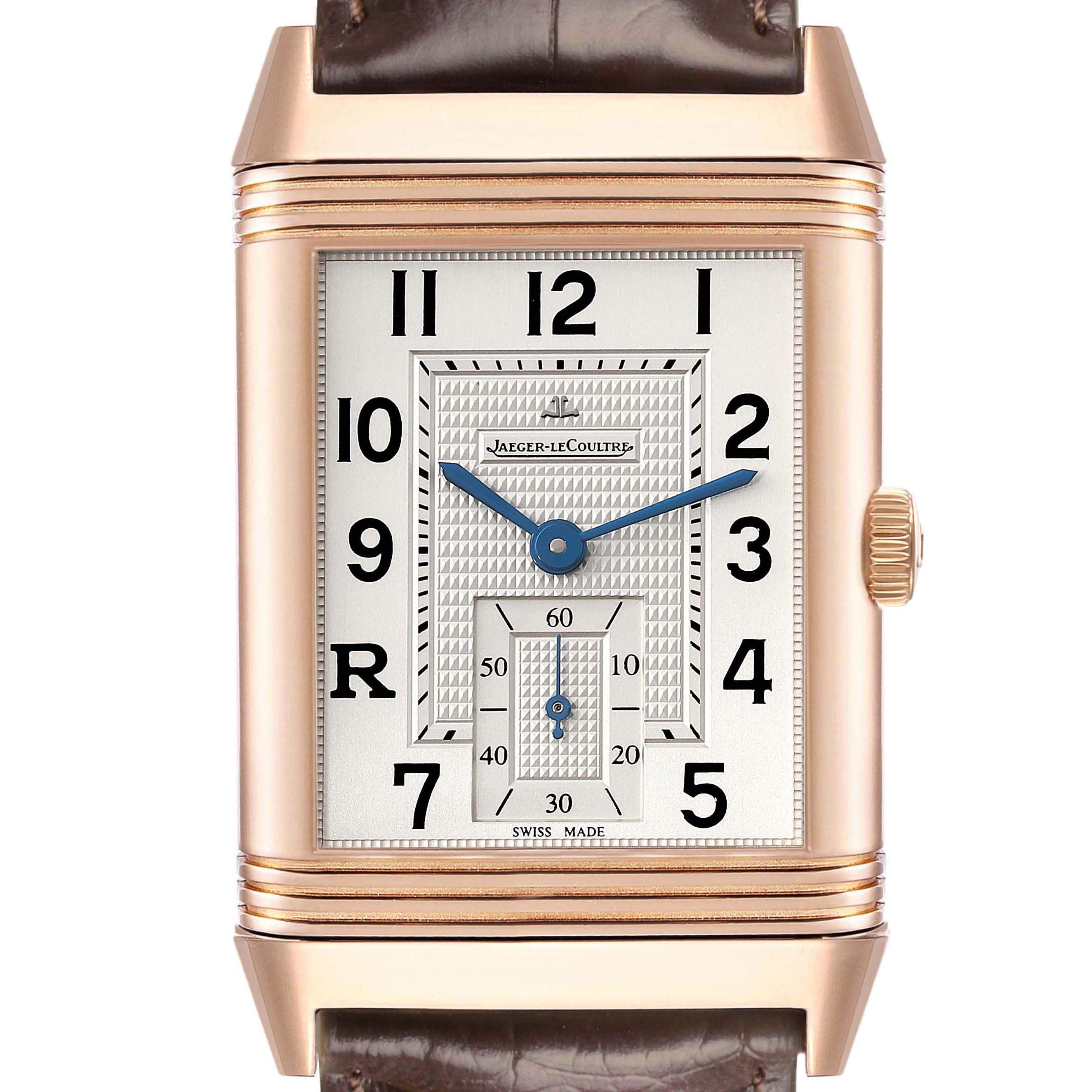 The Jaeger-LeCoultre Reverso watch is shown from the front, displaying the dial, hands, crown, and leather strap.